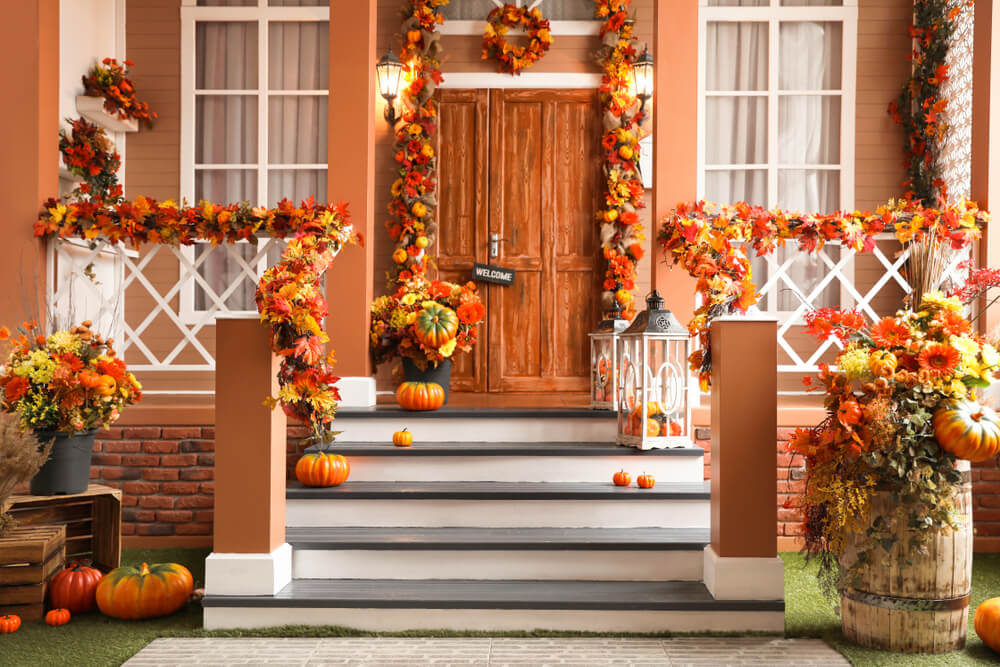 A front porch decorated with pumpkins for a cute Halloween party in October.