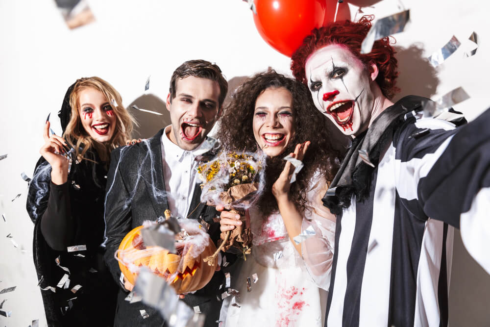 A group of friends celebrate Halloween with spooky costumes.