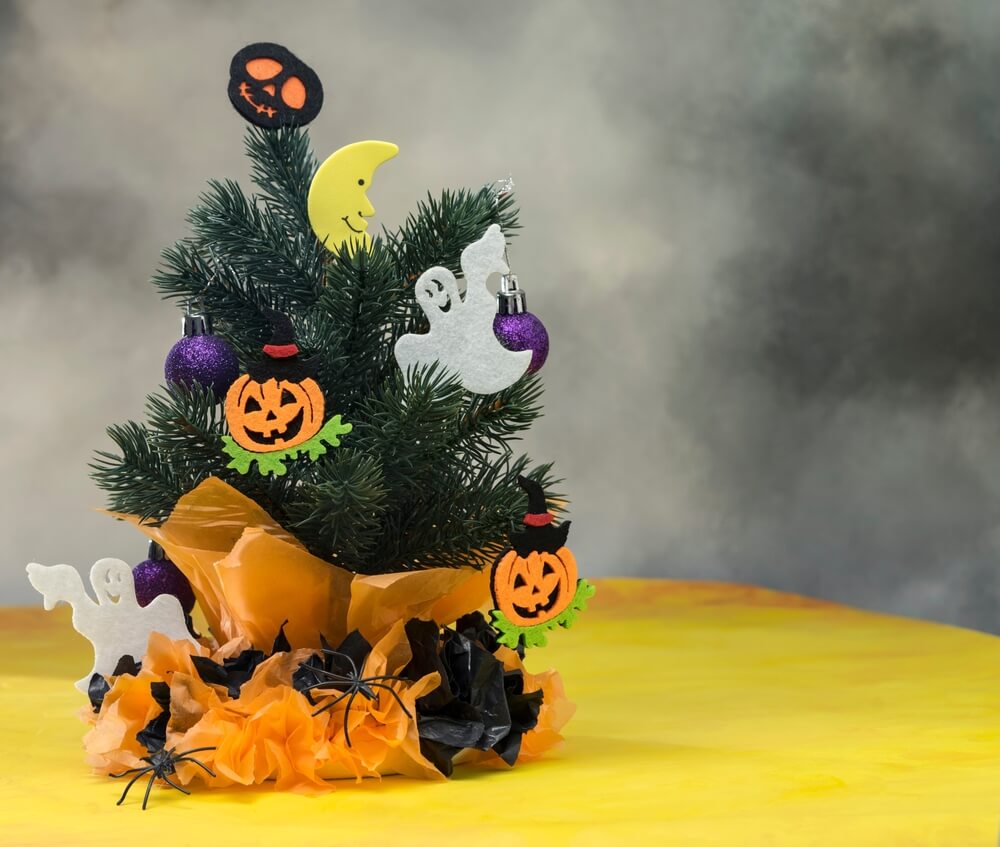 A cute holiday tree decorated with ghosts and pumpkins to celebrate Halloween.