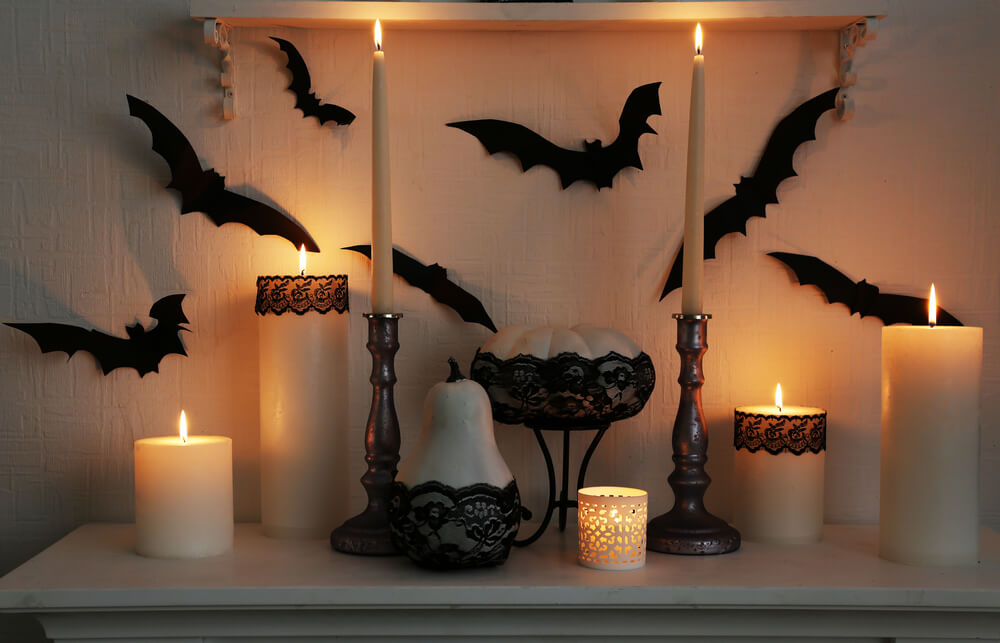 Elegant decorations with black lace and candles for a Halloween party.