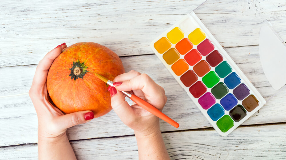 Pumpkin painting is the perfect crafting activity for a Halloween baby shower.
