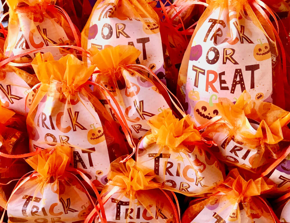 Treat bags for guests at a baby shower with a Halloween theme.