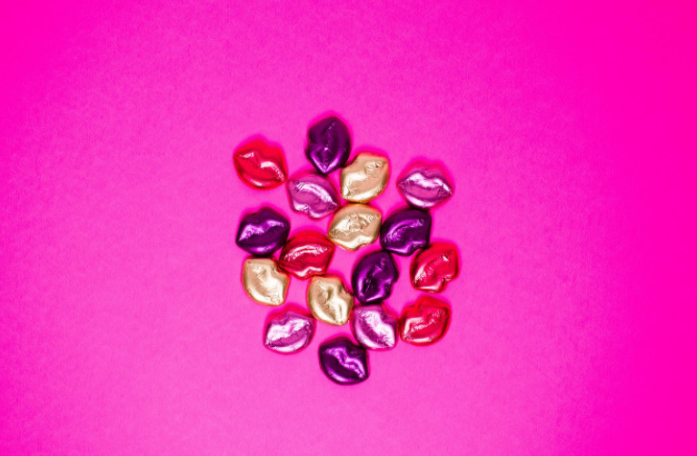 Colorfully wrapped chocolates shaped like Valentine’s Day lips. 