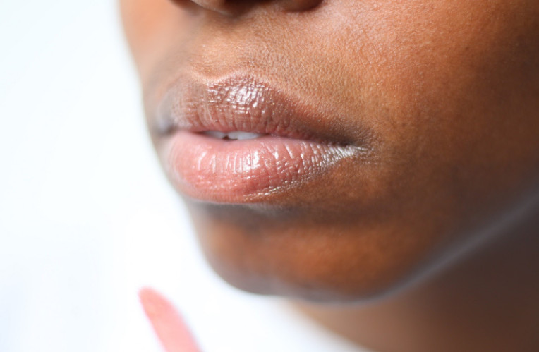 A woman wears lip balm to protect her lips during the winter months.