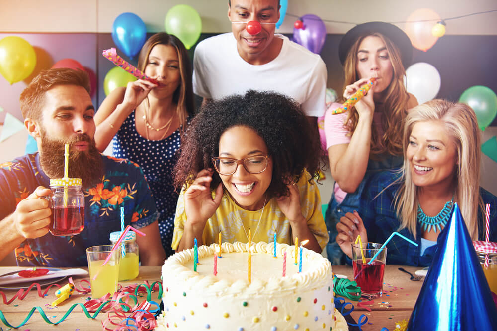 A Libra woman celebrates her birthday surrounded by friends.