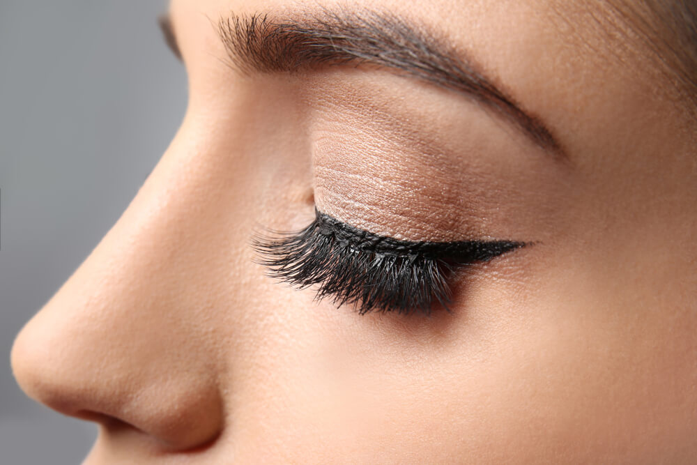 A Libra woman with false eyelashes is ready to attend an elegant event.