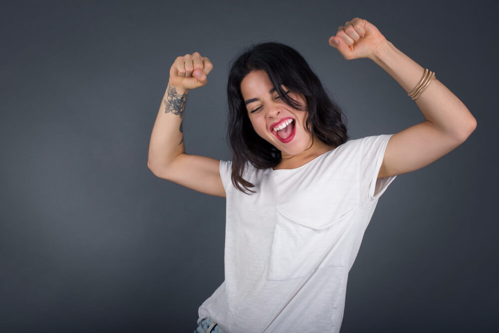 A woman with a temporary tattoo is ready to party on her birthday.