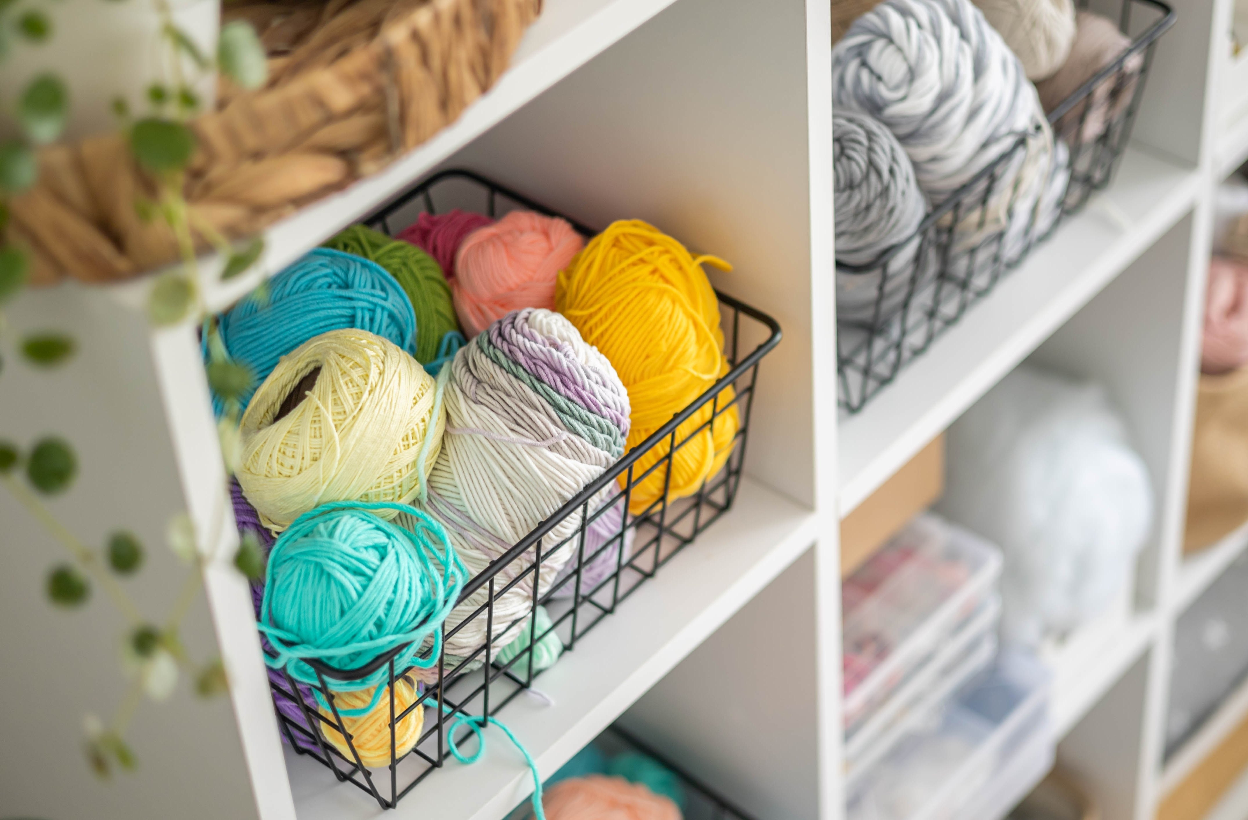 Yarn and other hobby supplies organized in a storage cupboard for a crafty girlfriend.