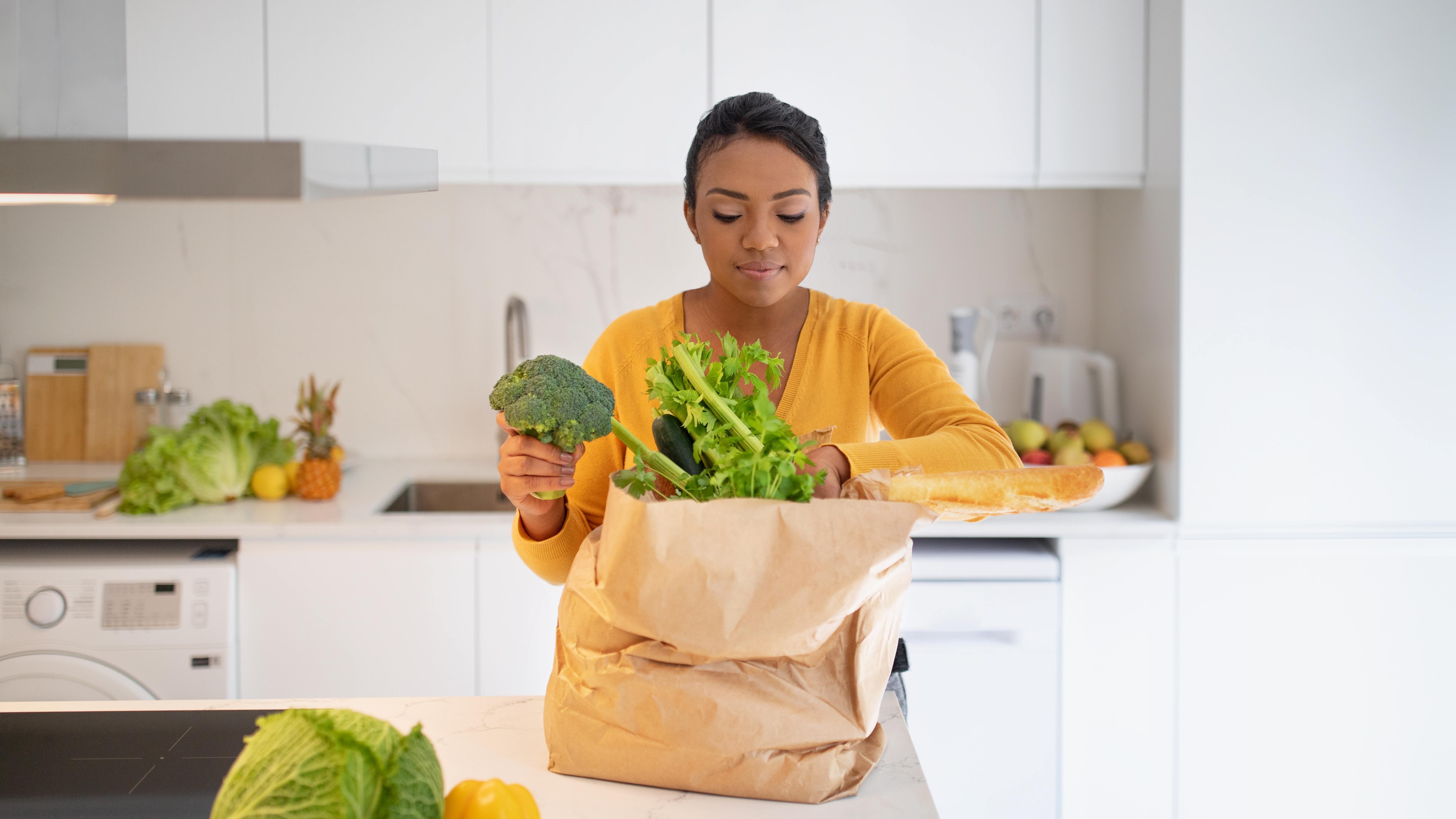 A healthy woman unpacks the fresh produce subscription she received for Valentine’s Day.