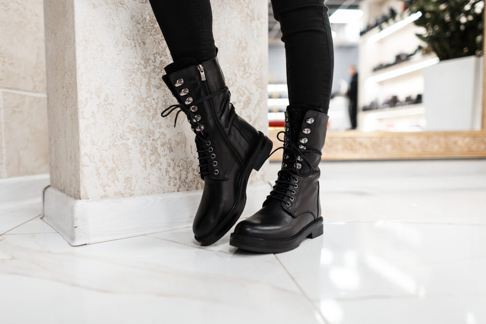 A Scorpio woman wears black boots to match her mysterious zodiac sign.