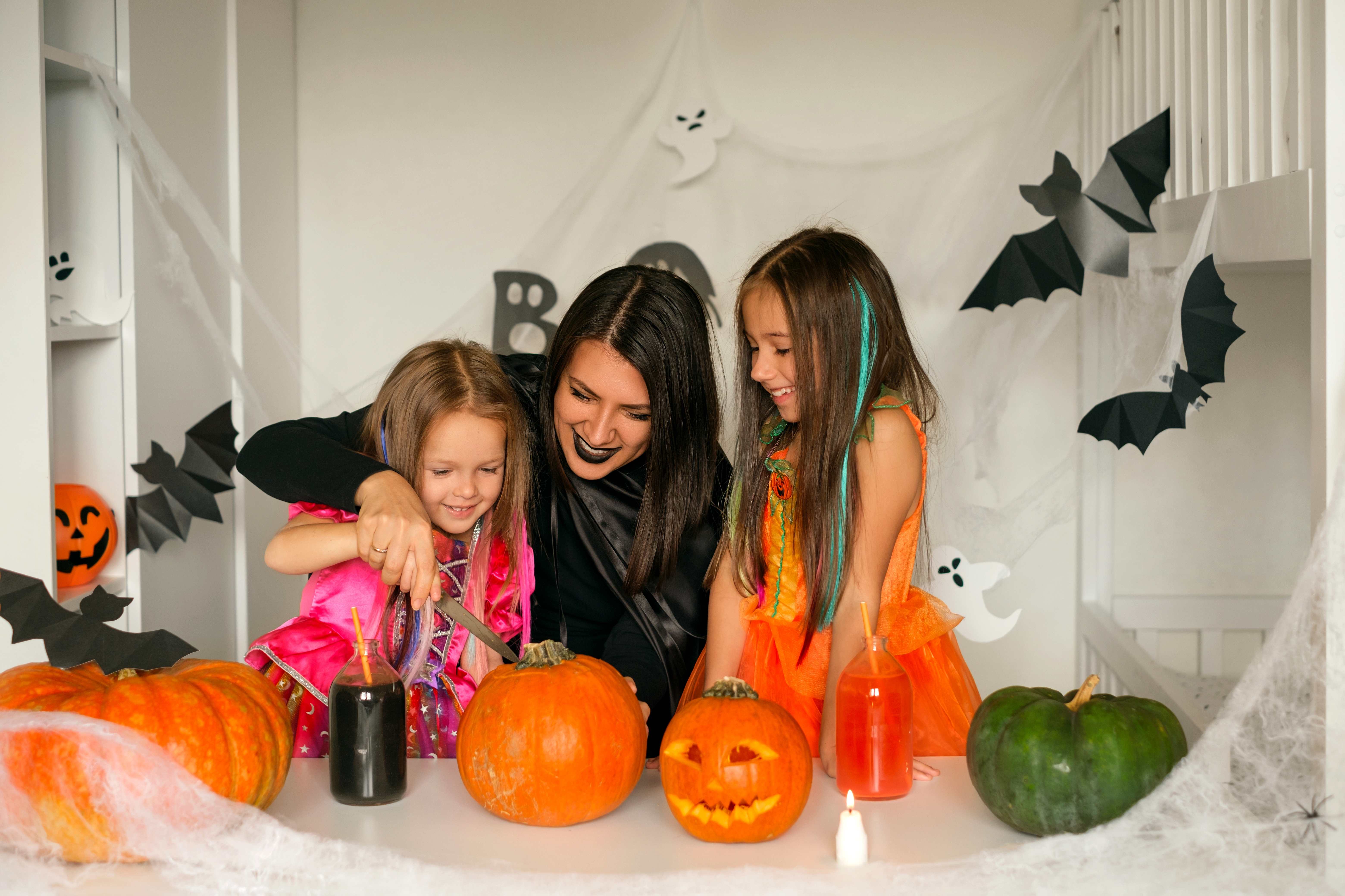 A cute family celebrates October with pumpkin carving and fun Halloween activities