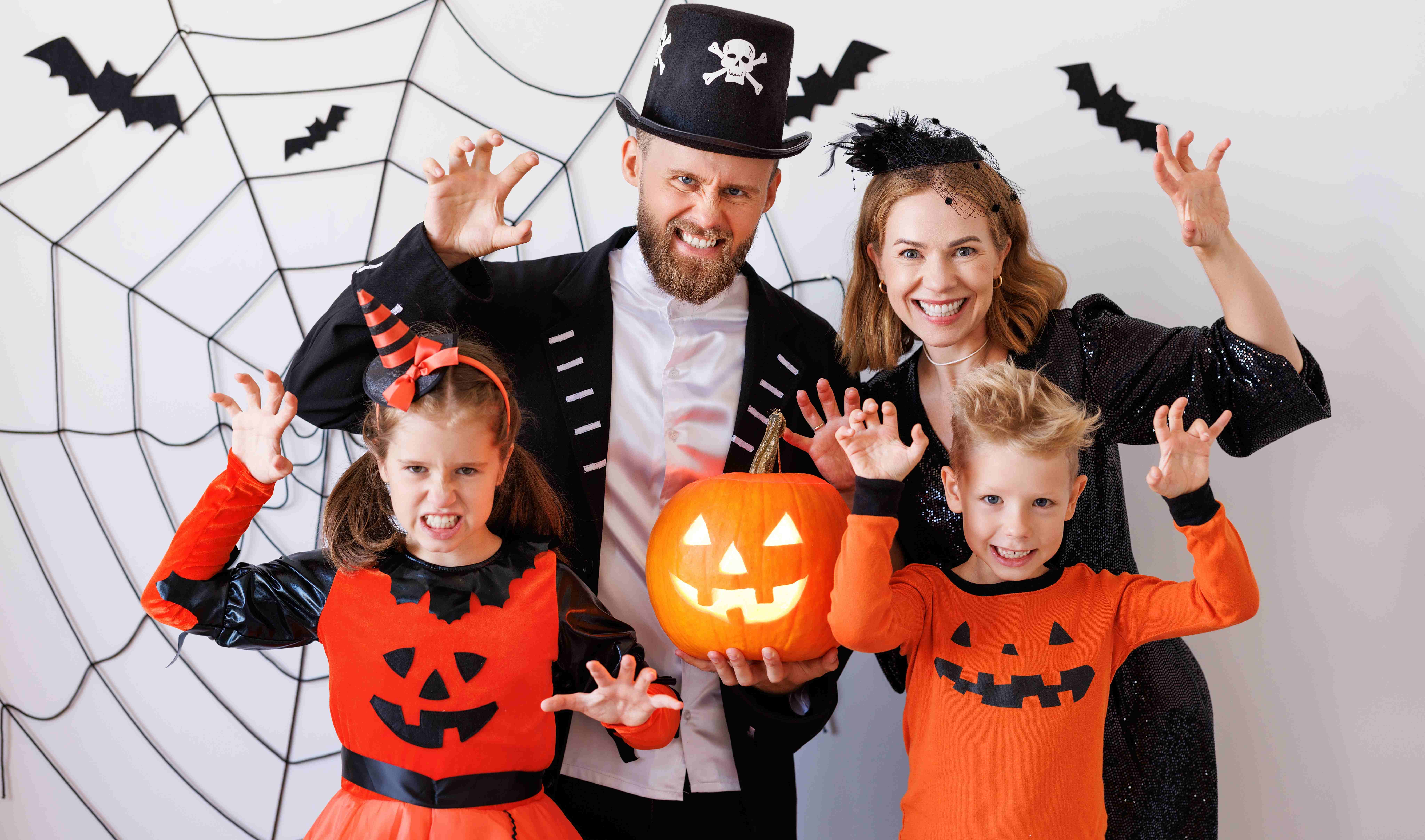 Parents and kids pose for a picture in their family Halloween costumes