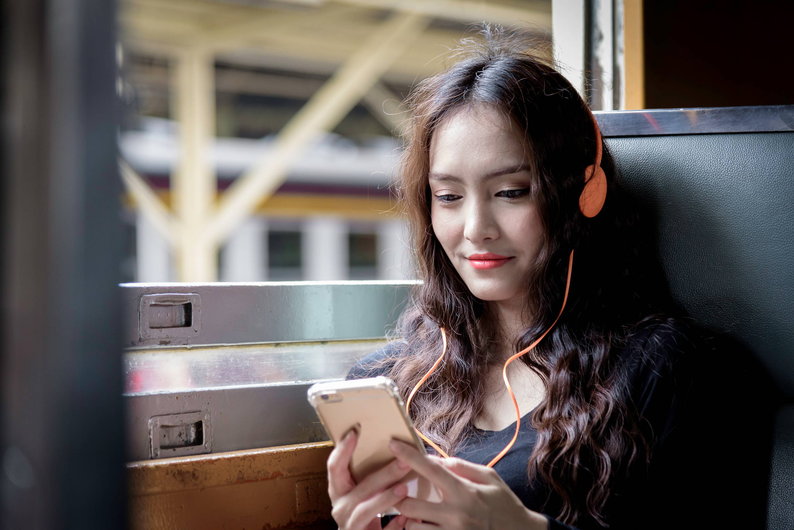 A book lover listens to an audiobook from her smartphone. 