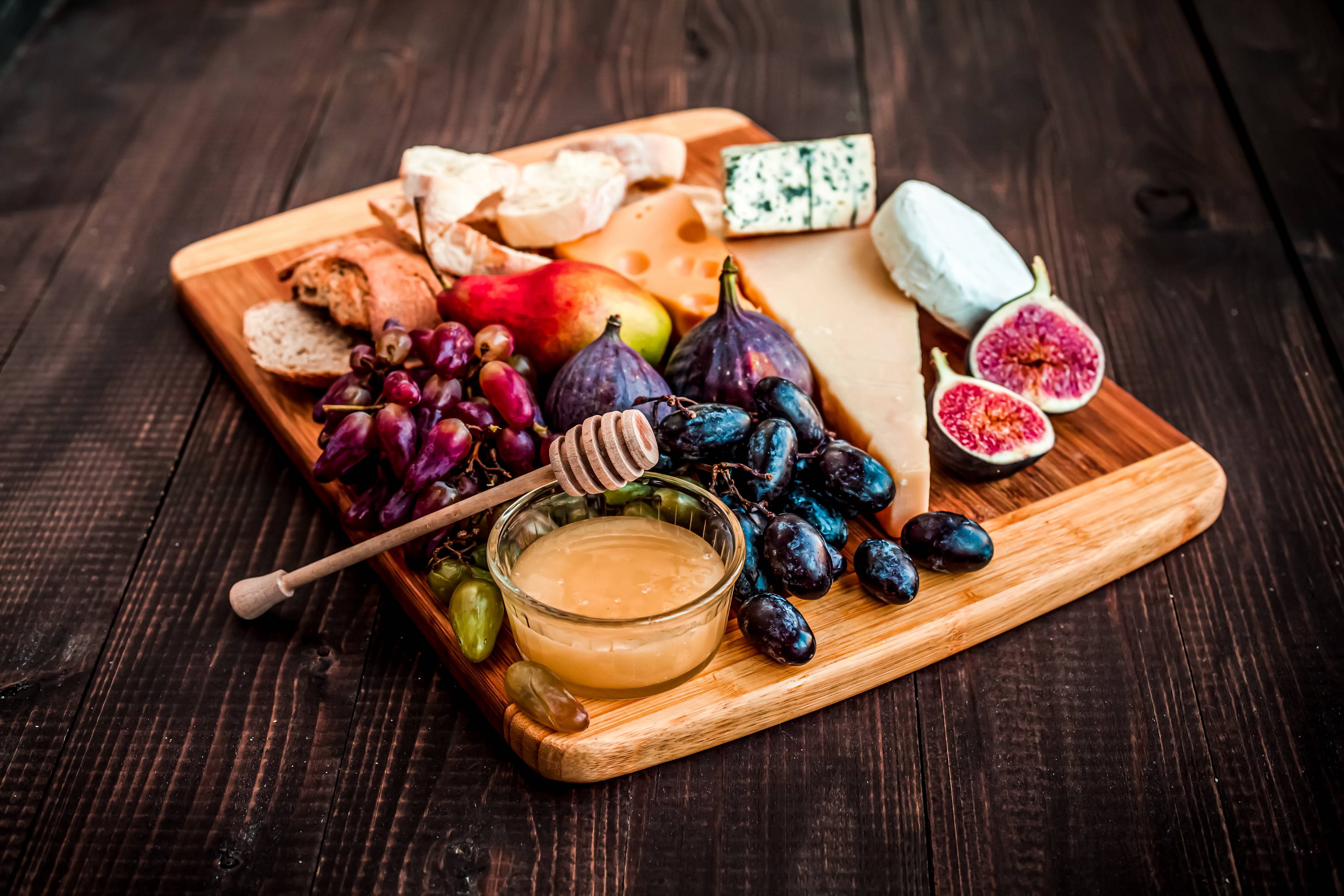 A charcuterie board with fruit and cheese for holiday entertaining.