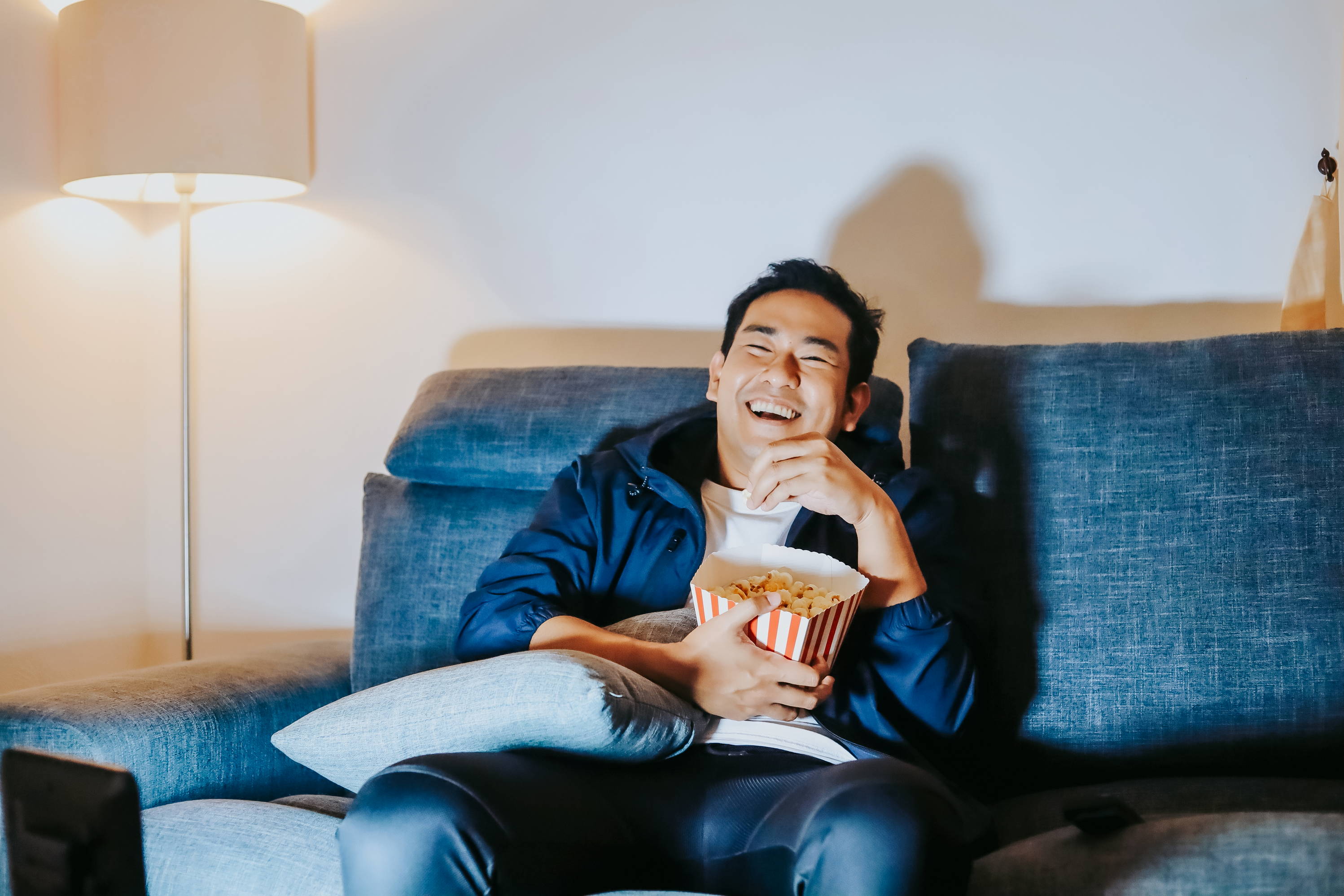 A man enjoys watching his favorite DVDs at home. 