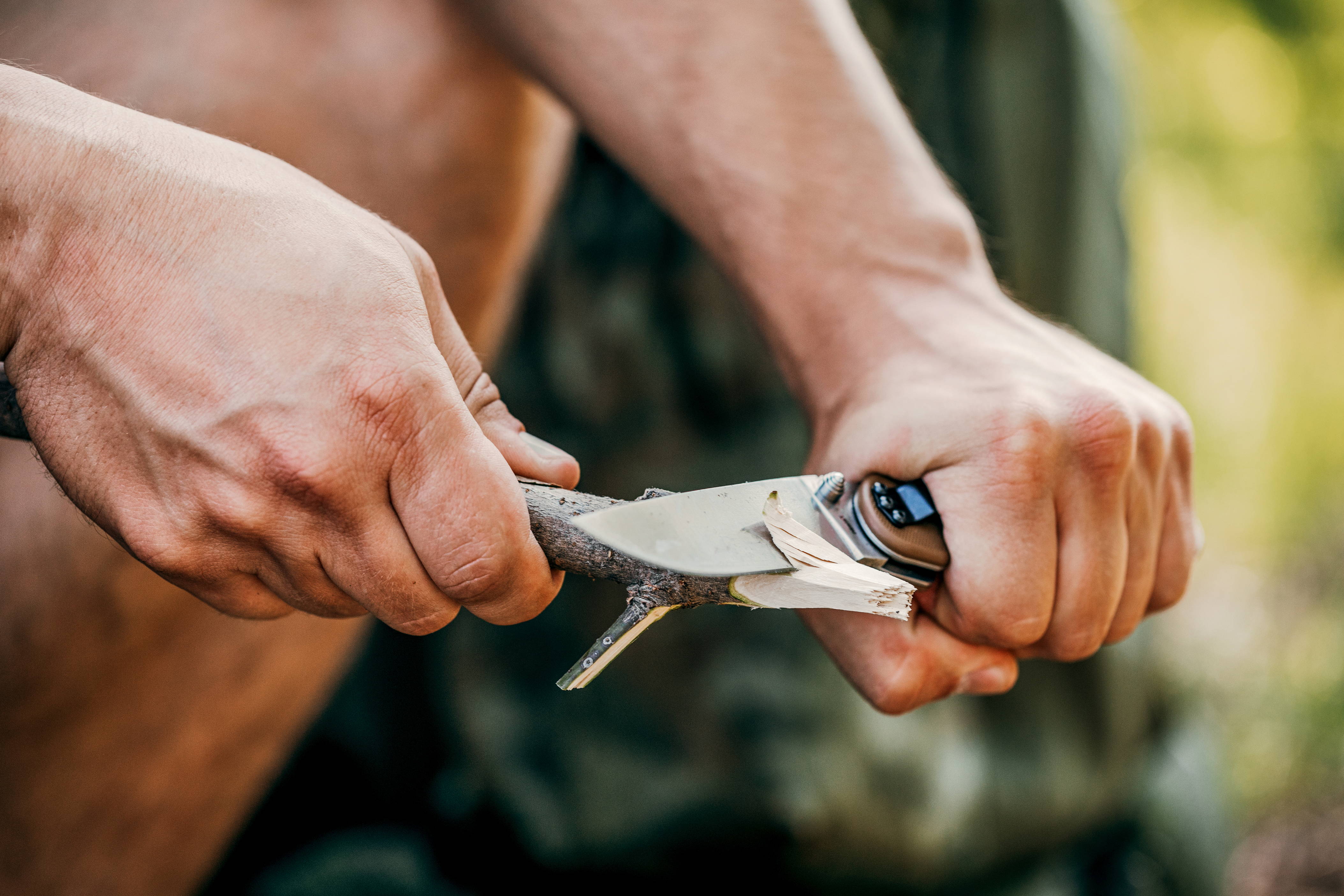 A man tries out the pocket knife he received during the holidays. 