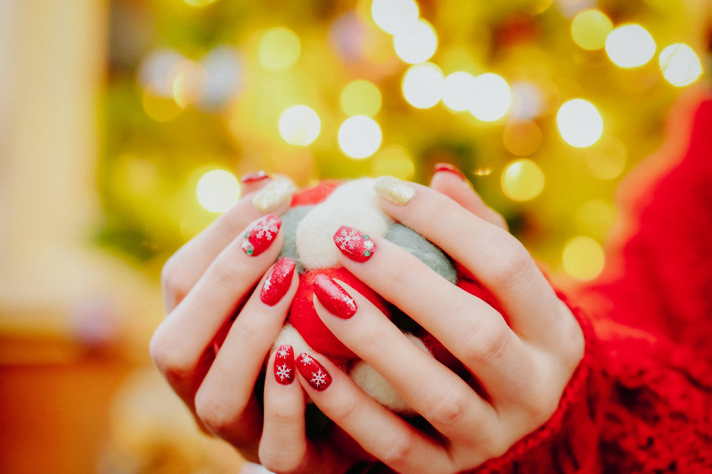 A woman shows off her festive holiday manicure at Christmas time. 