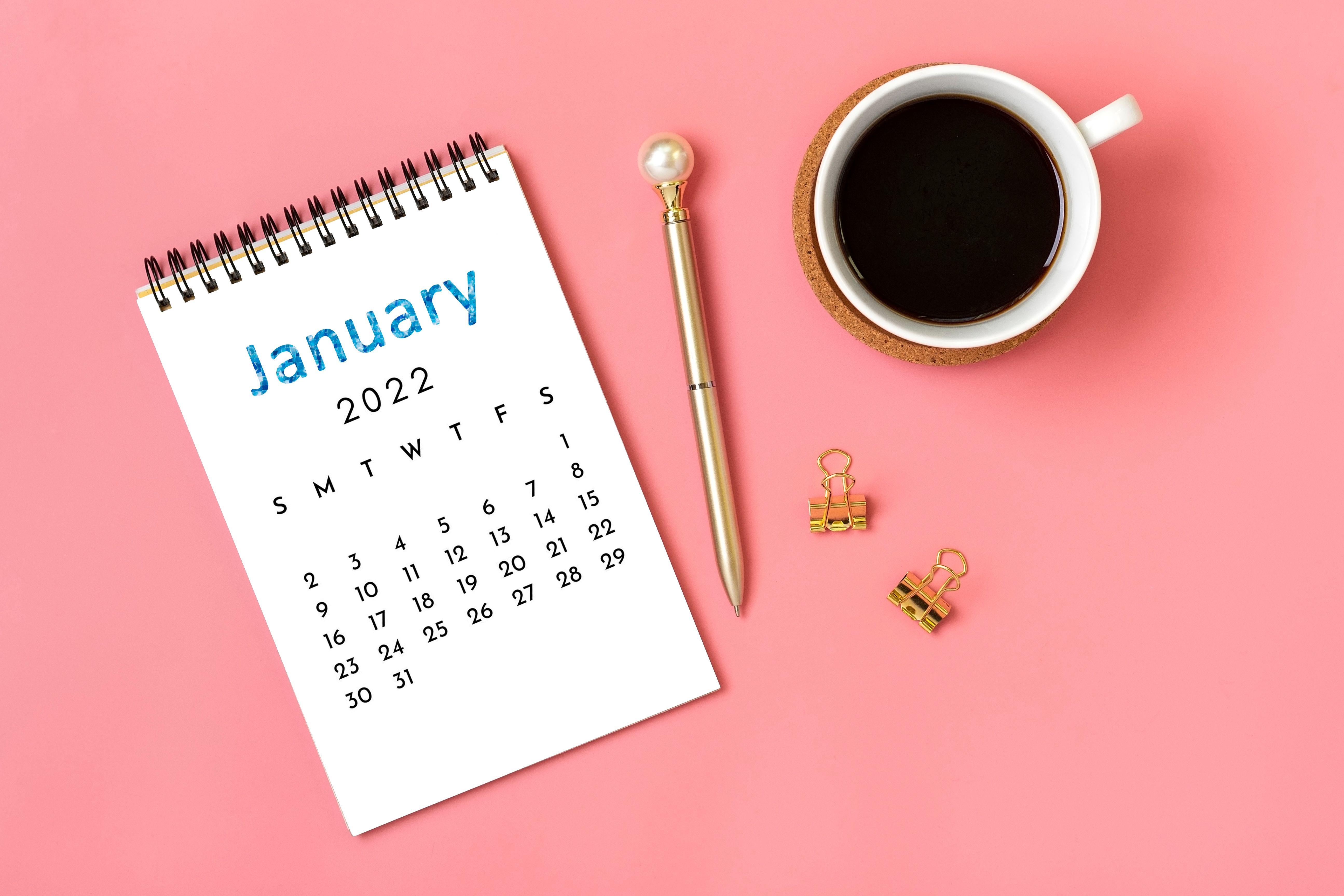 An open 2022 calendar and a cup of coffee prepare us to start a new year.