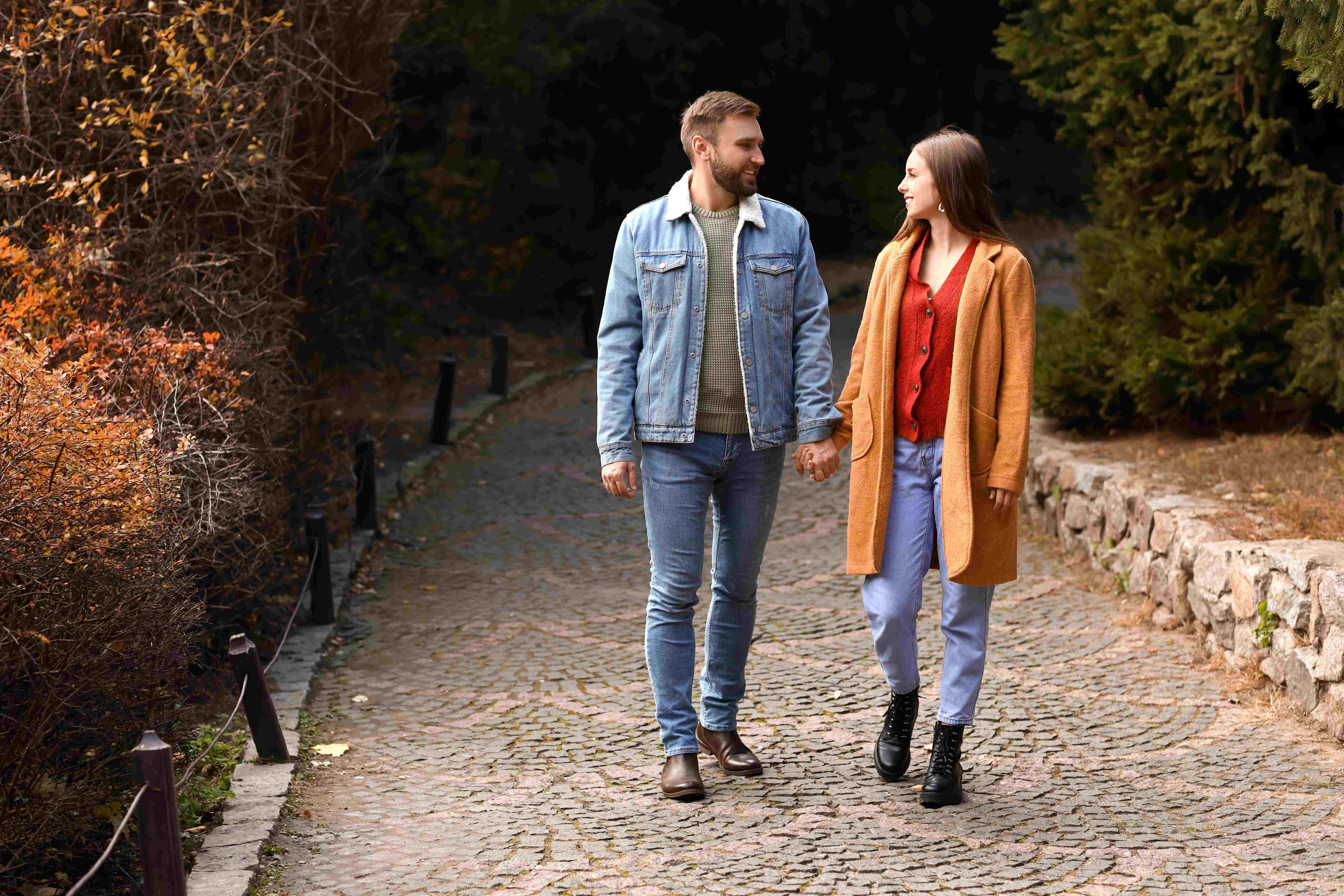 A loving couple enjoys a daytime date at the park.