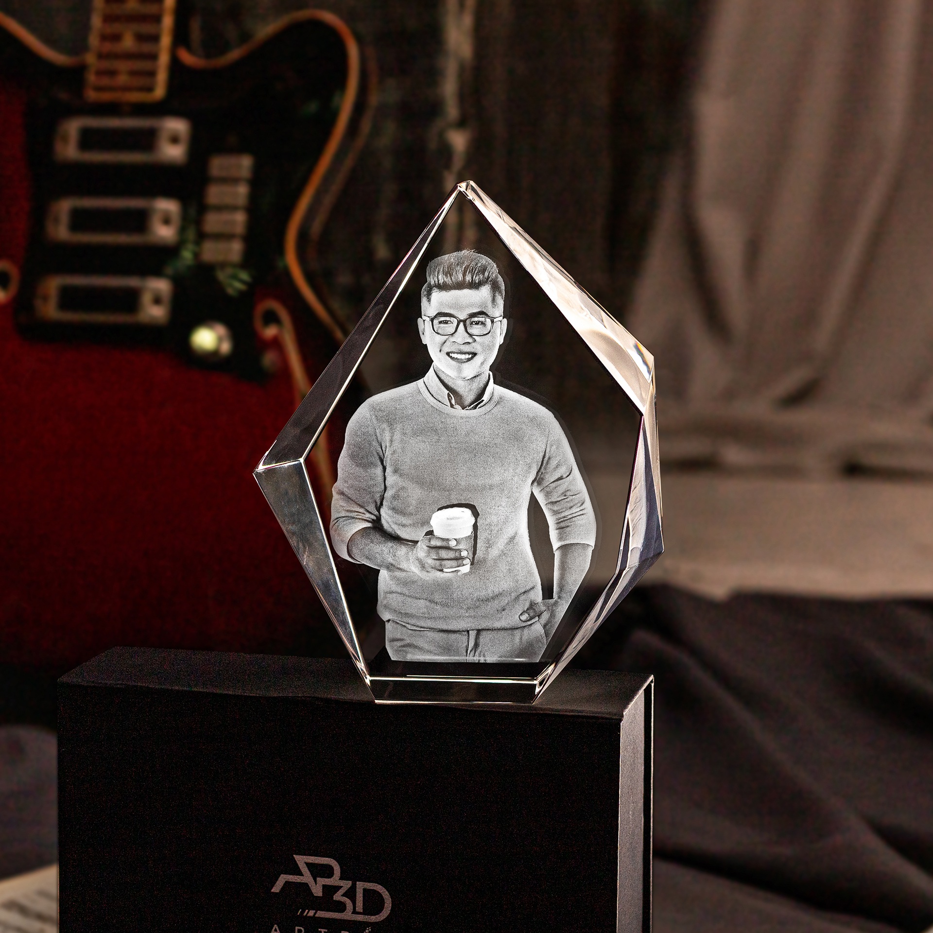 A photo of a successful Capricorn man engraved inside a 3D crystal gift.