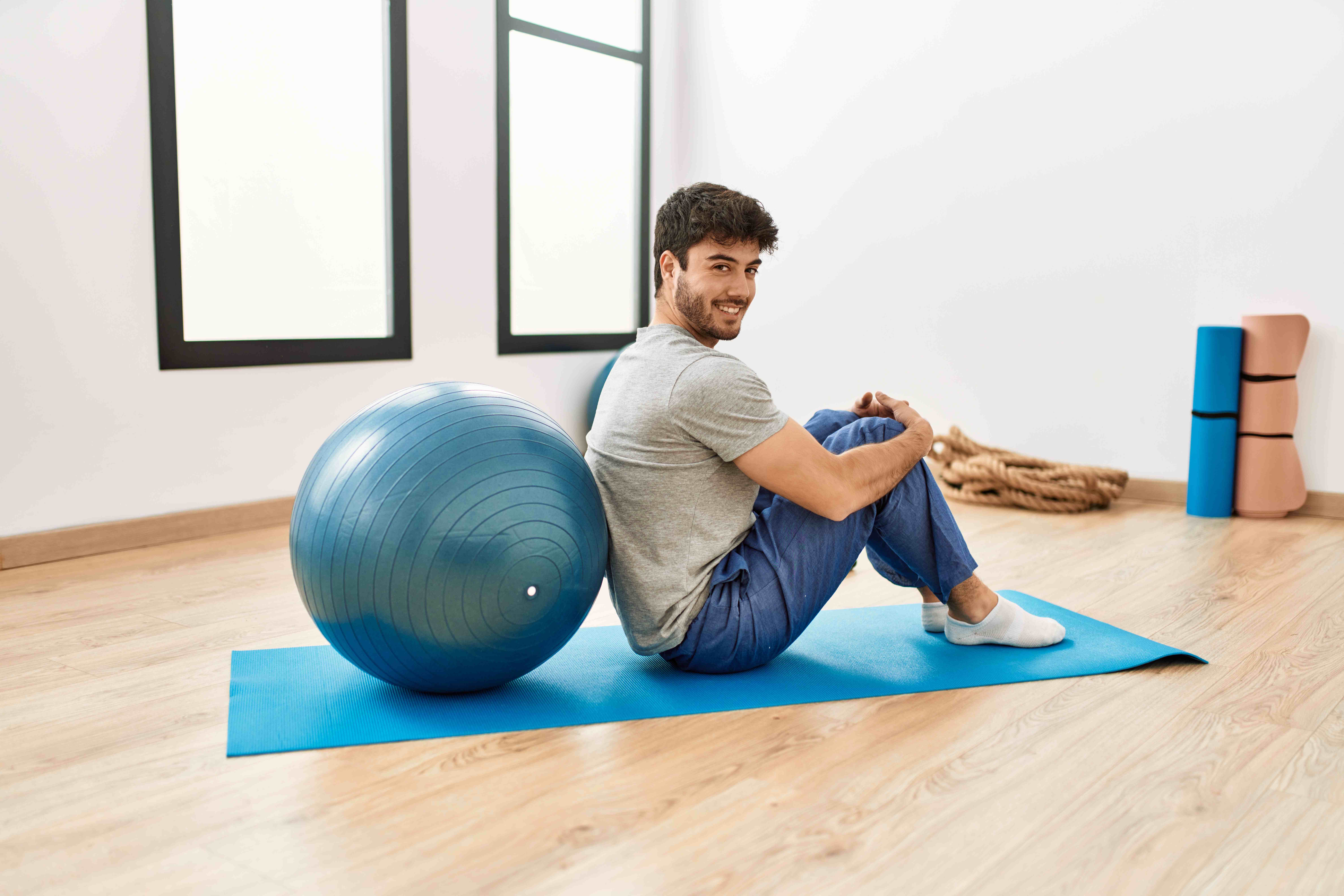 A fit man uses his new exercise ball as part of his workout routine. 