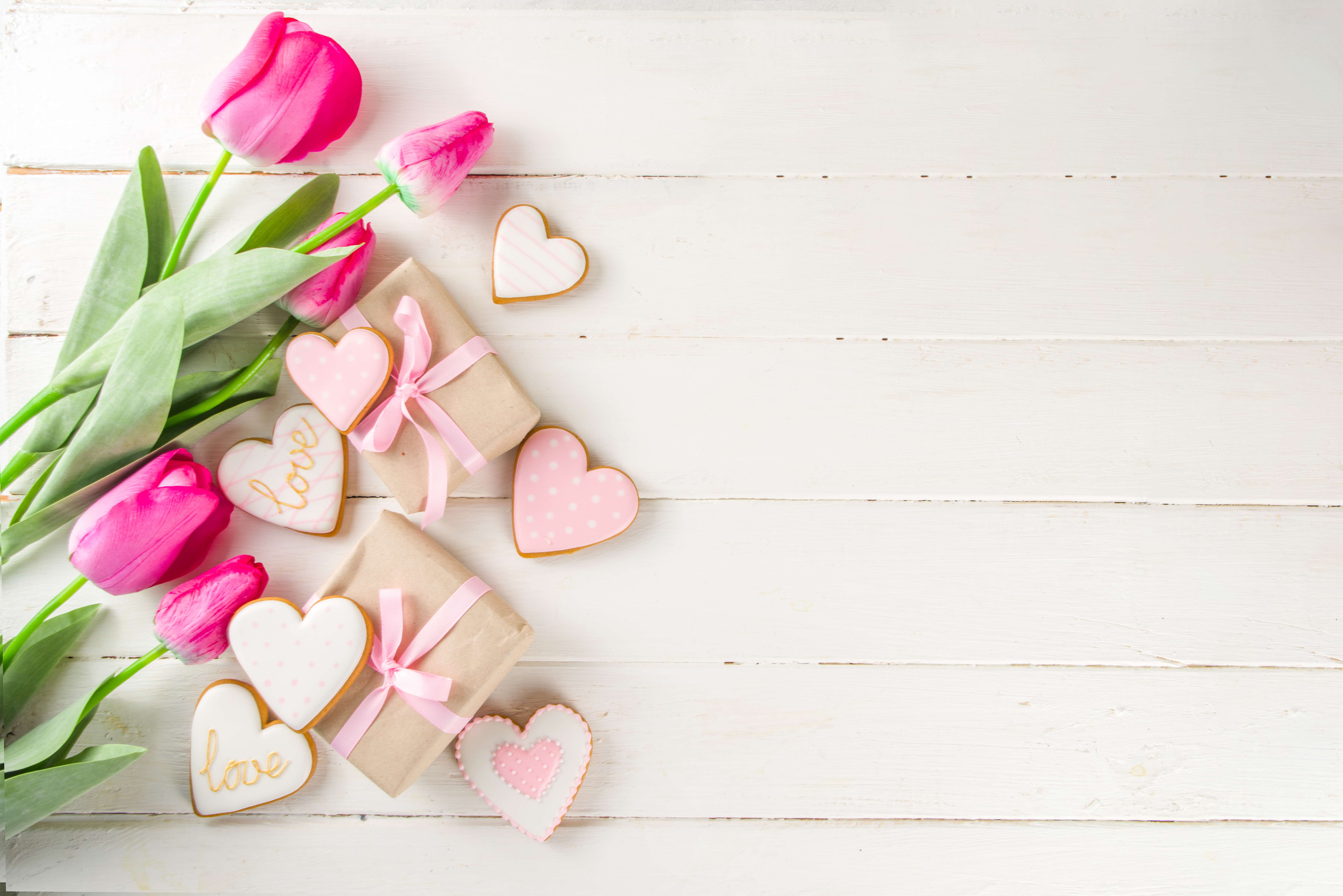 A romantic bouquet of pink tulips and heart-shaped cookies.