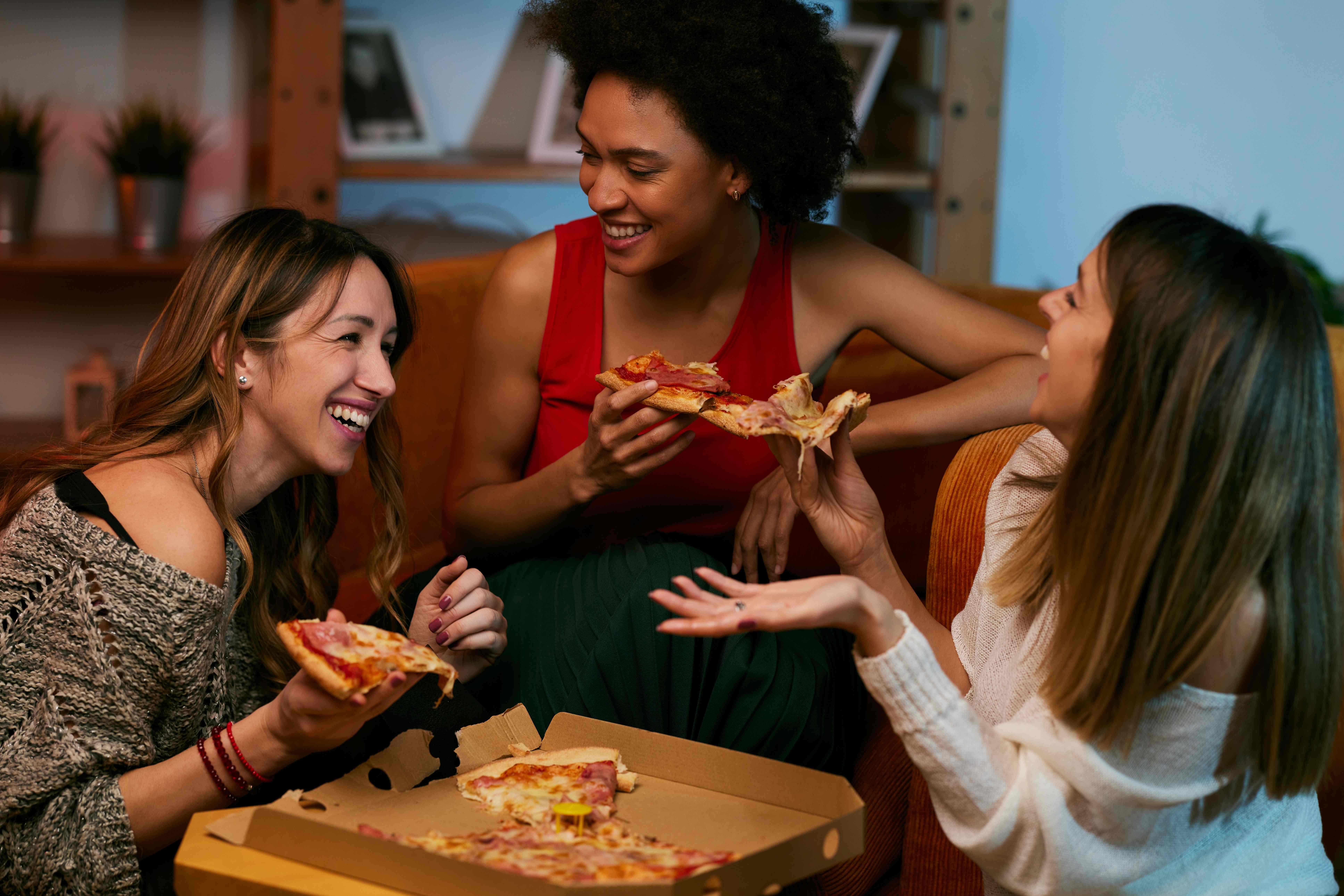 Three single friends celebrate Valentine’s Day together with pizza.