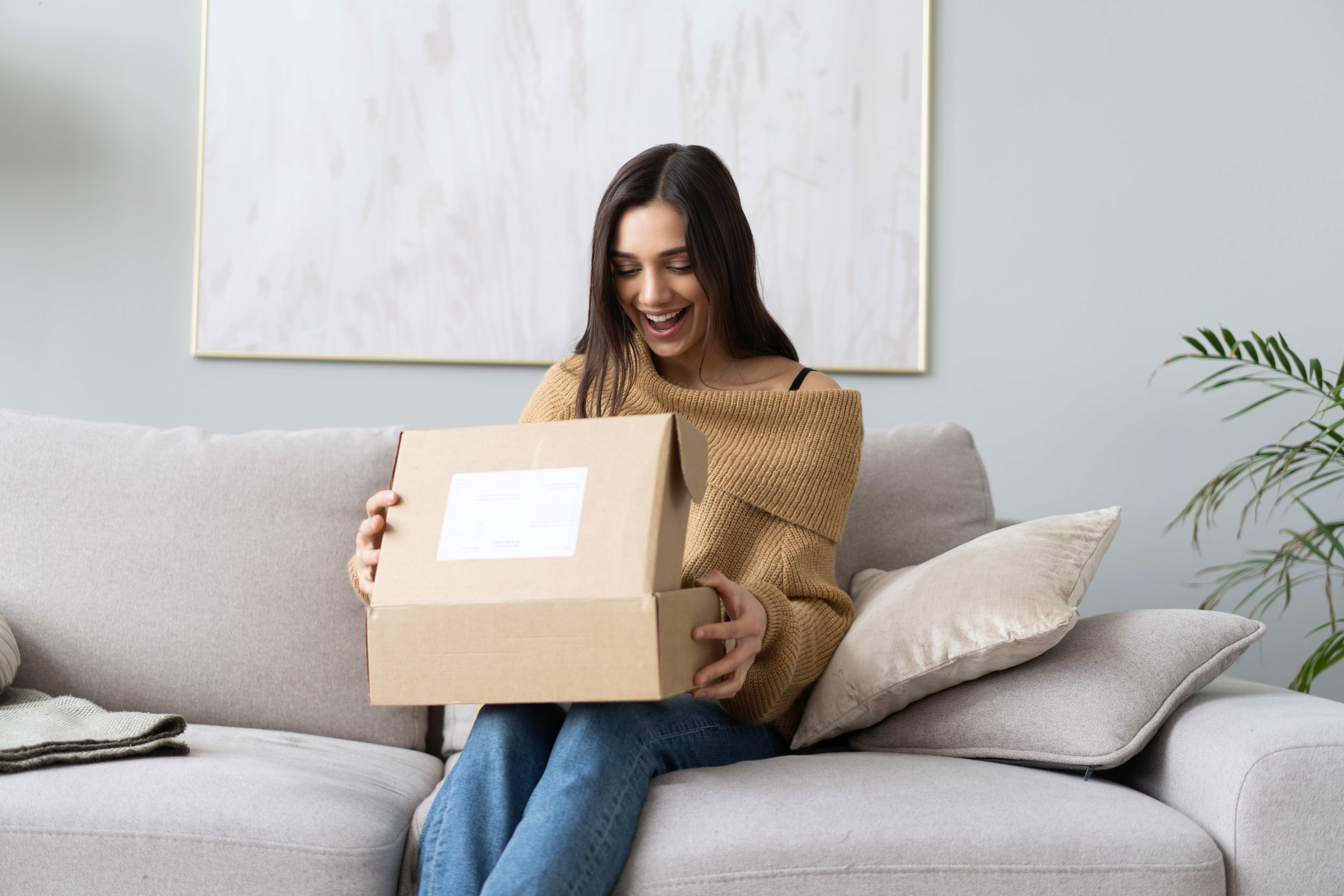 An Aquarius woman receives a subscription box in the mail for her birthday. 