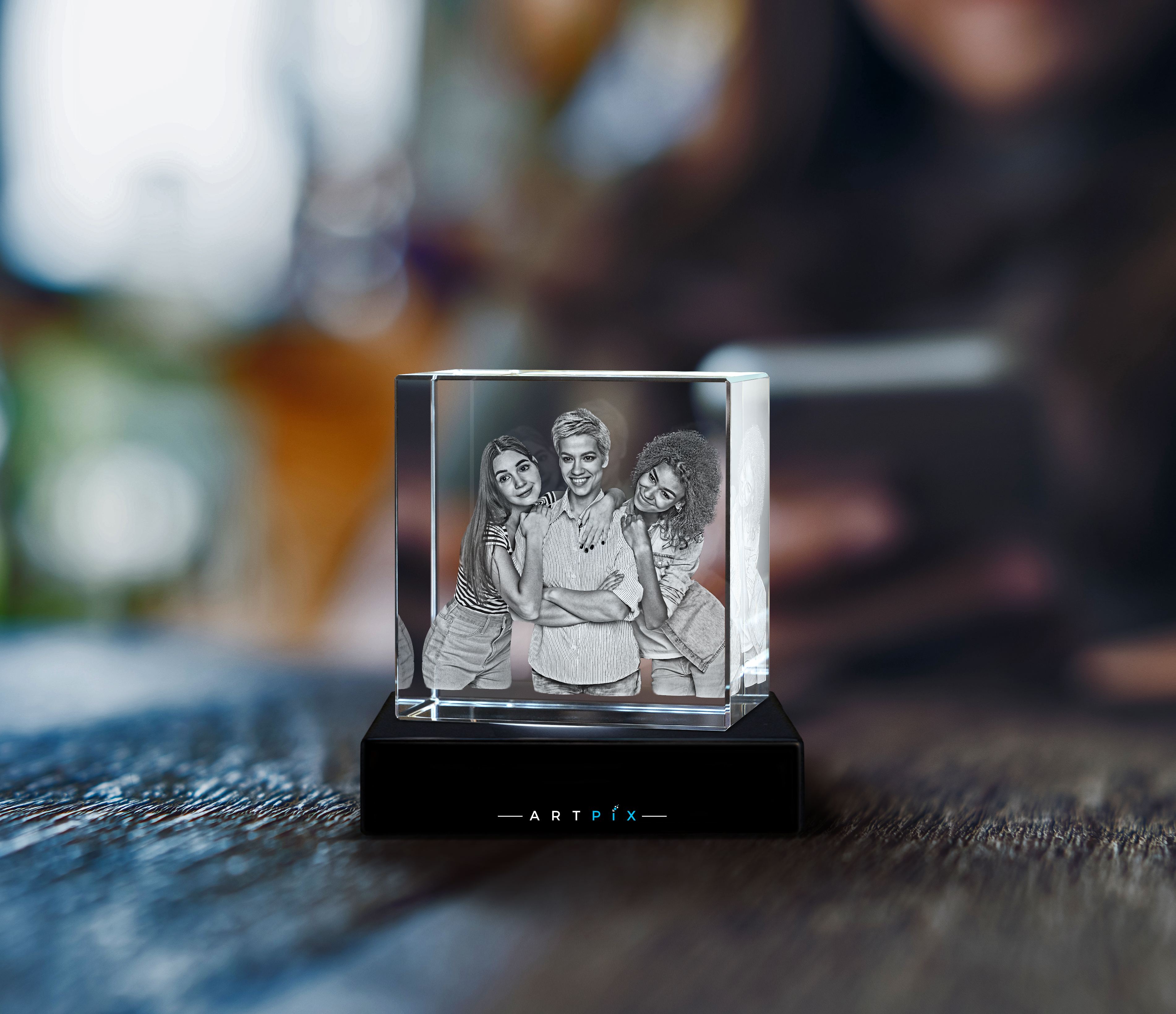 A 3D Photo Crystal with a picture of three female friends engraved inside.