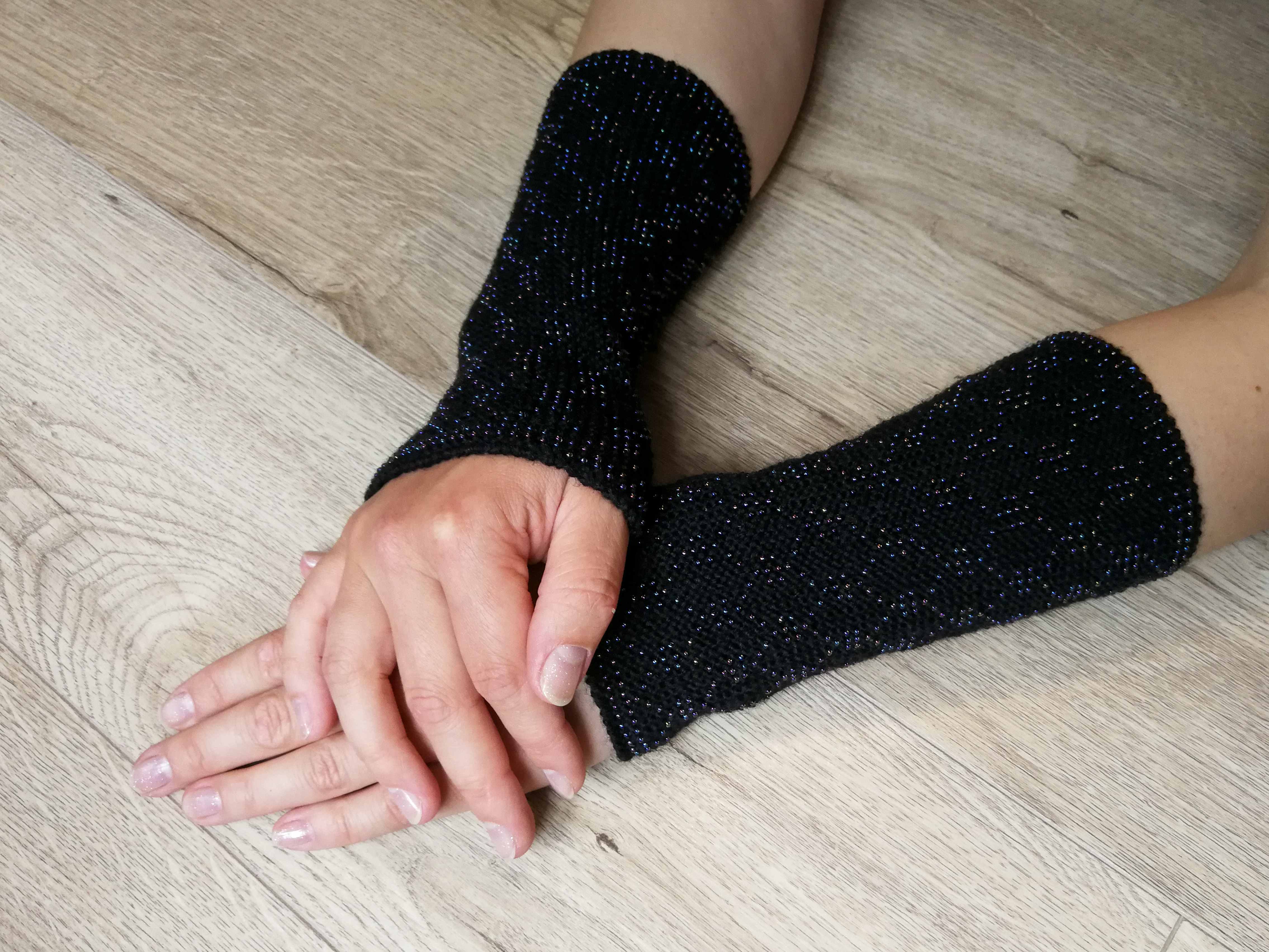 A woman wears a pair of unique arm warmers to express her personal style.