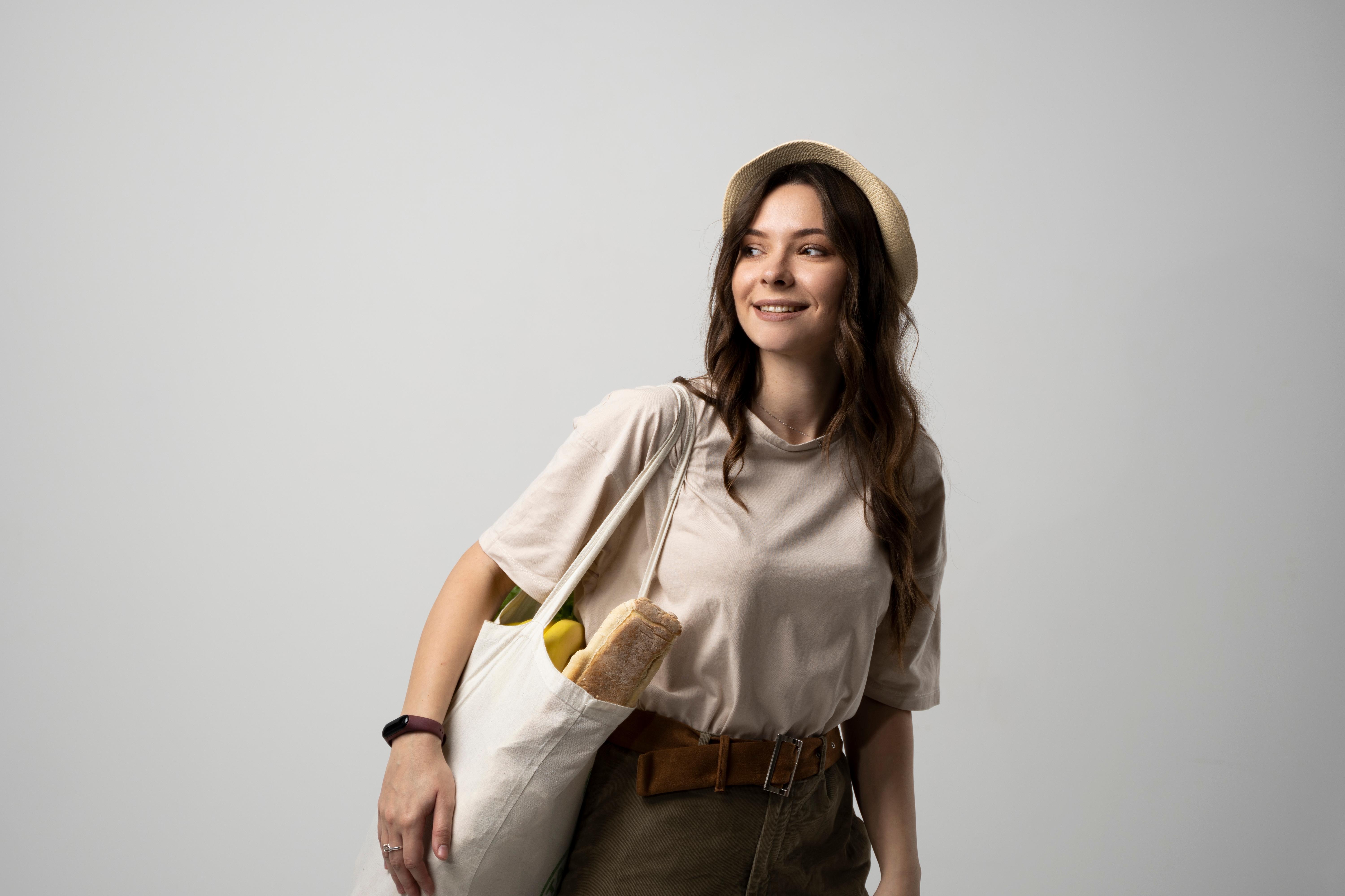 An eco-friendly Aquarius woman carries her groceries in a cloth bag. 