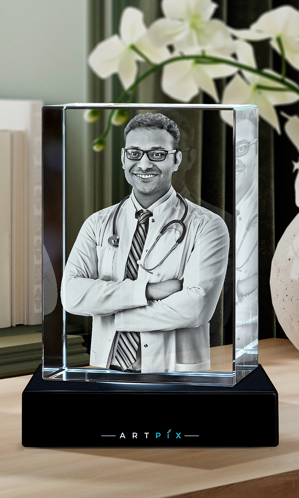 A 3D photo of a successful doctor engraved inside a crystal award.