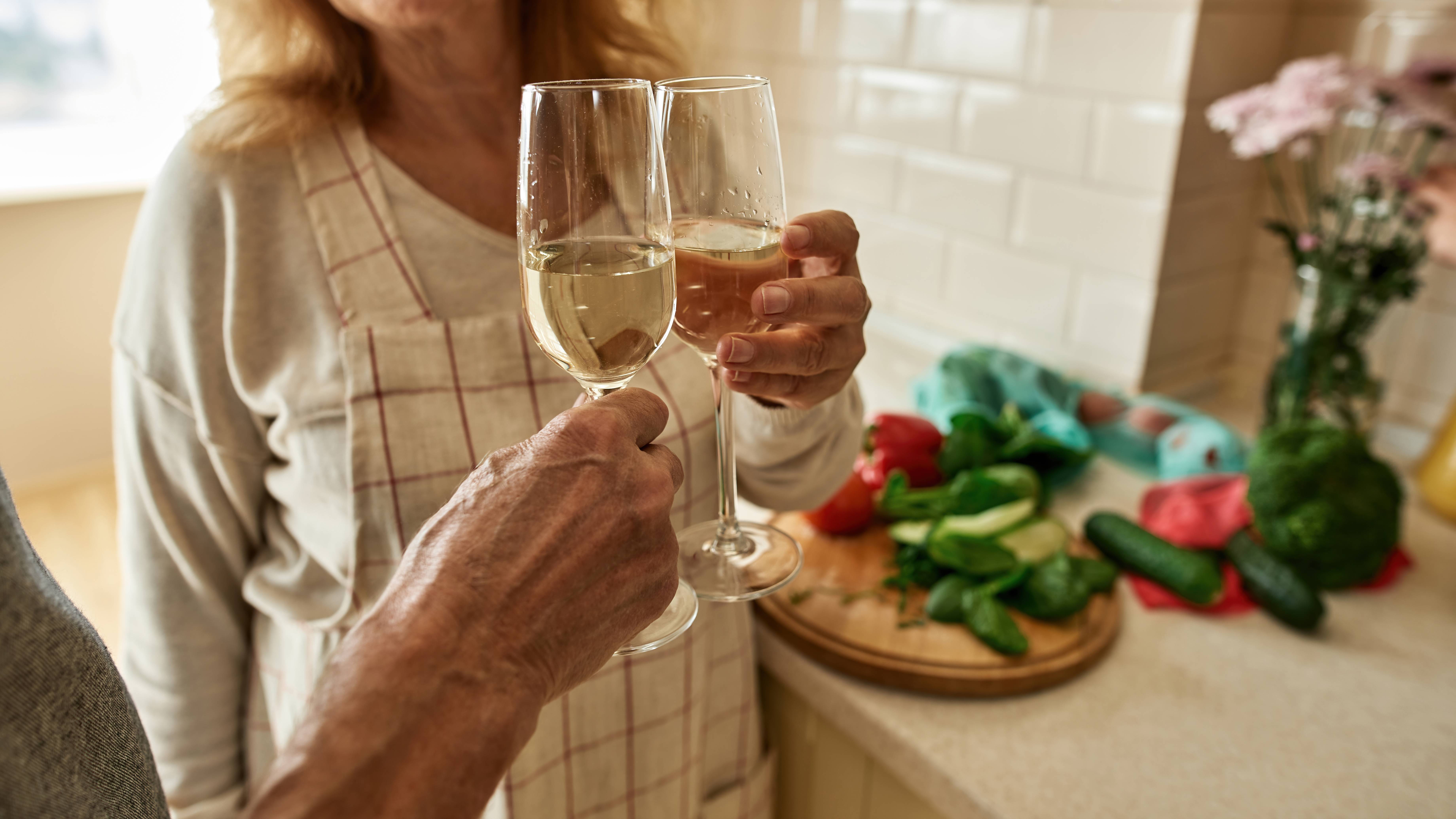 A couple celebrates the end of their successful careers with a glass of wine.