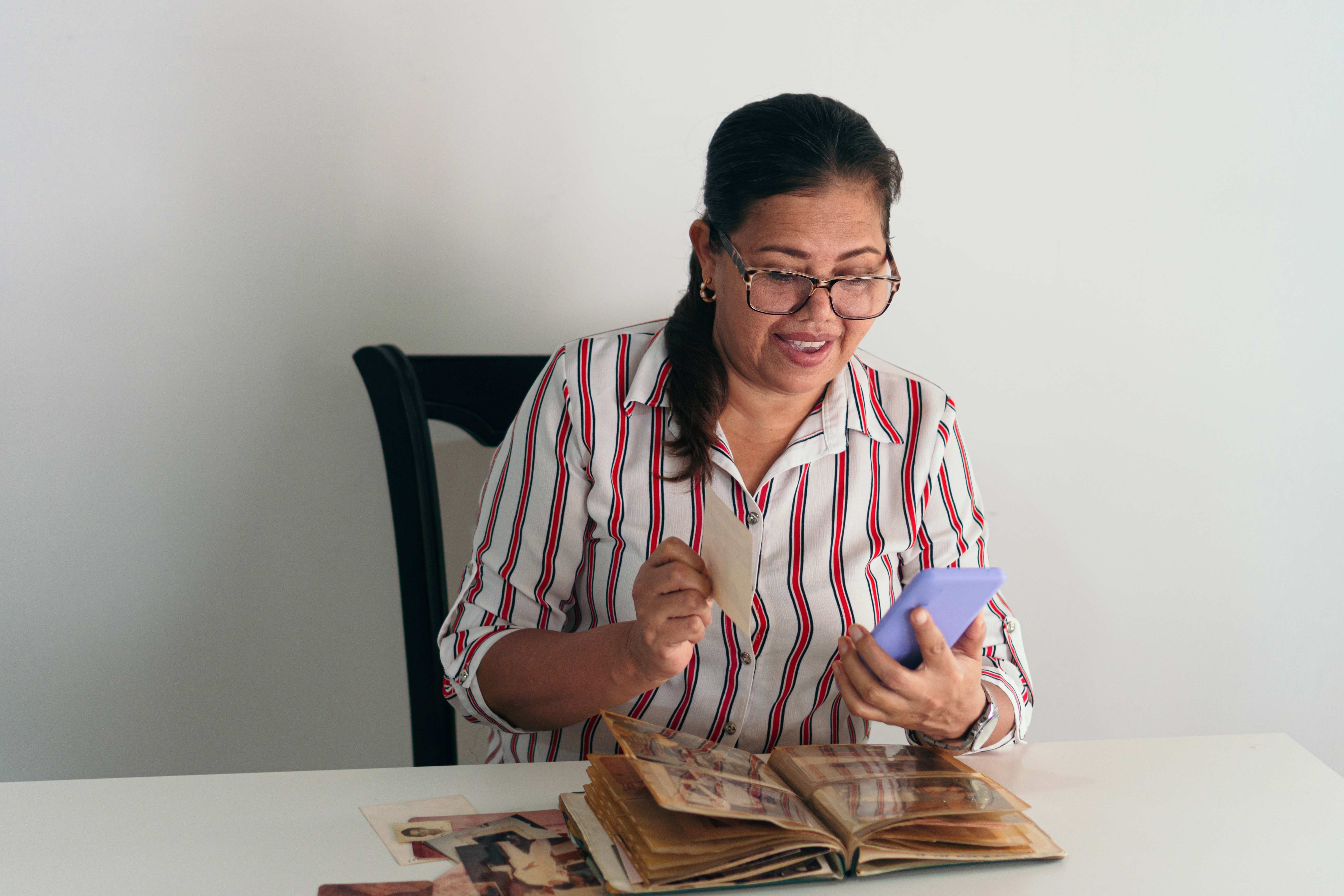 A senior woman is delighted to see her favorite photos in an album.