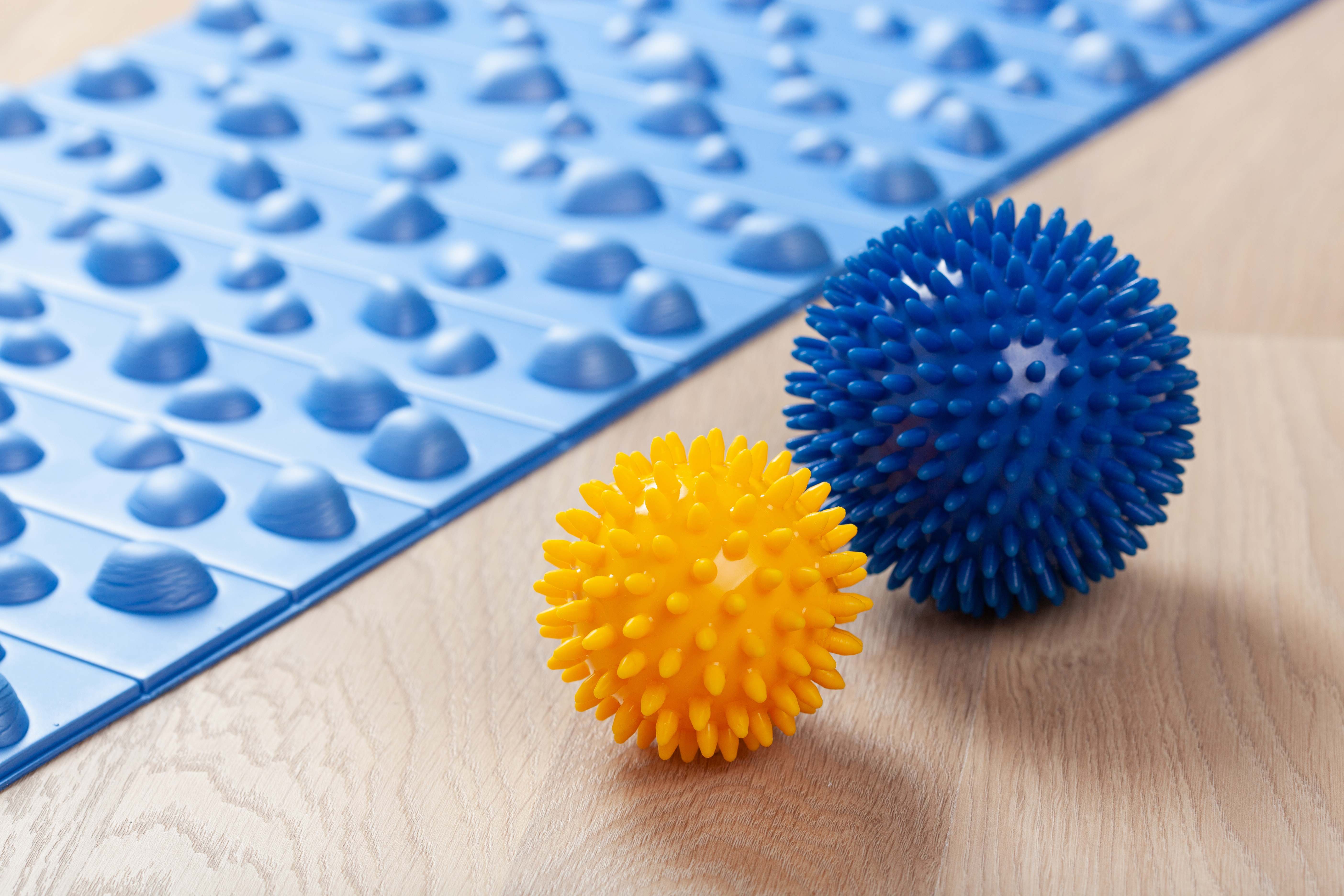 A pair of massage balls for soothing sore muscles at home.