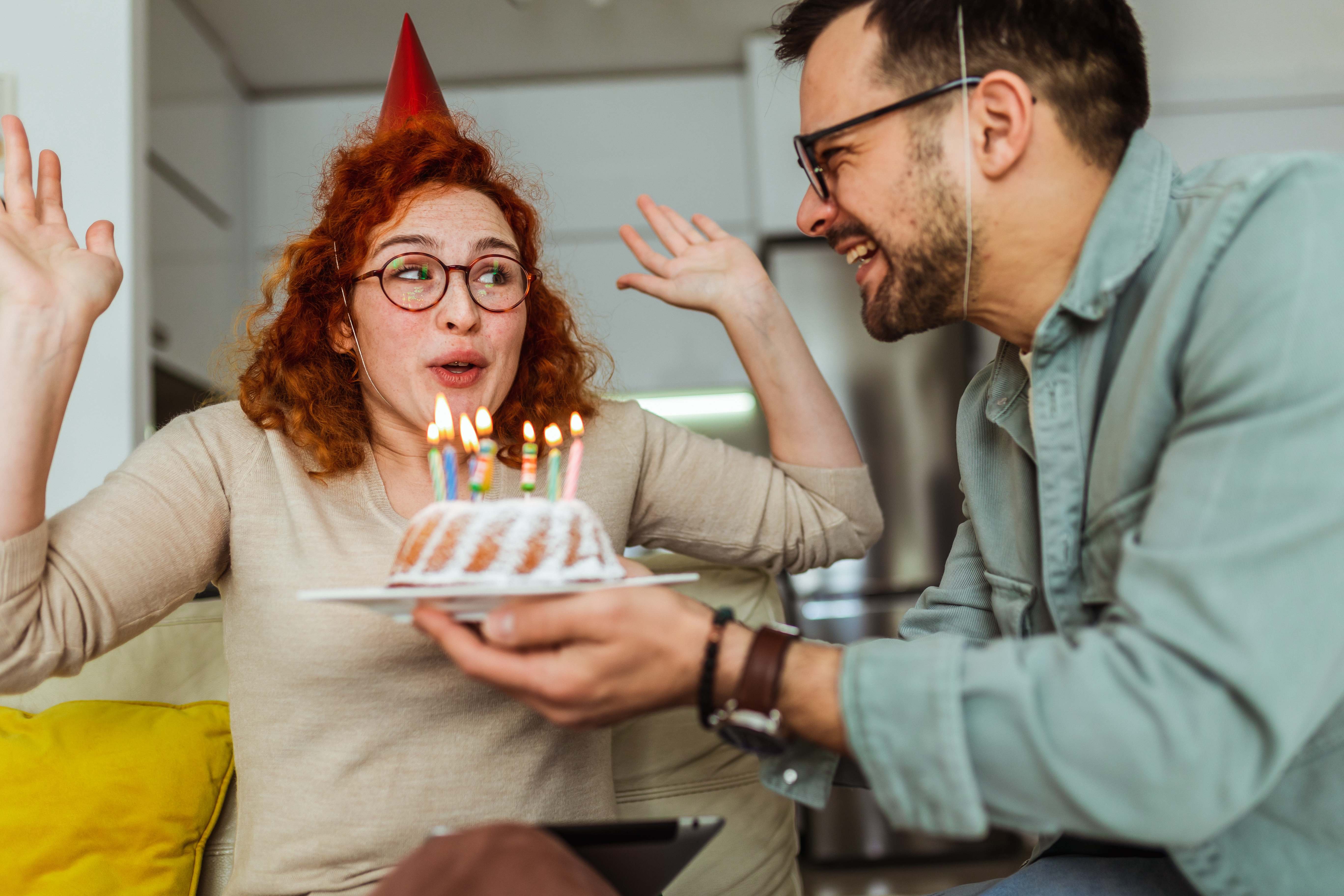 A loving boyfriend celebrates his Pisces girlfriend’s birthday with cake.
