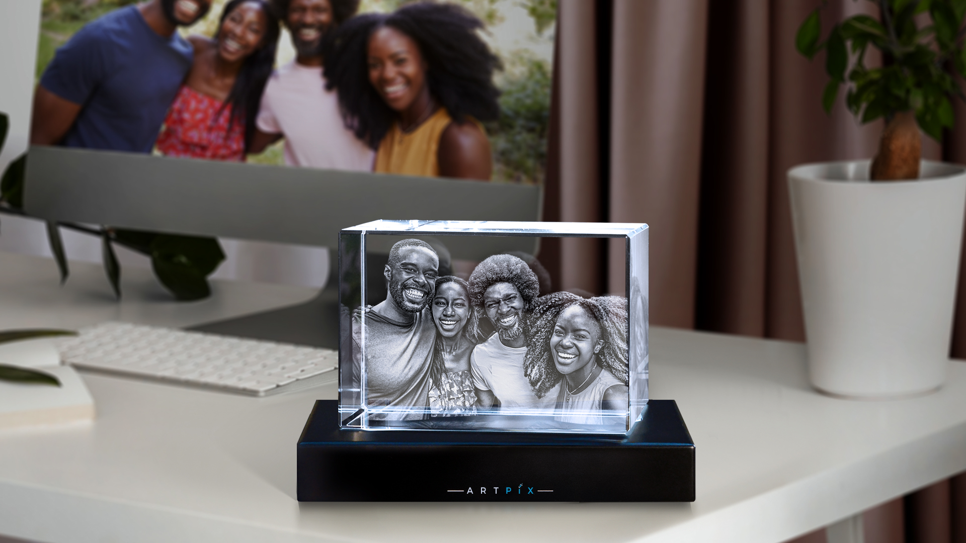 A photo of a happy group of friends engraved in 3D inside a crystal gift. 