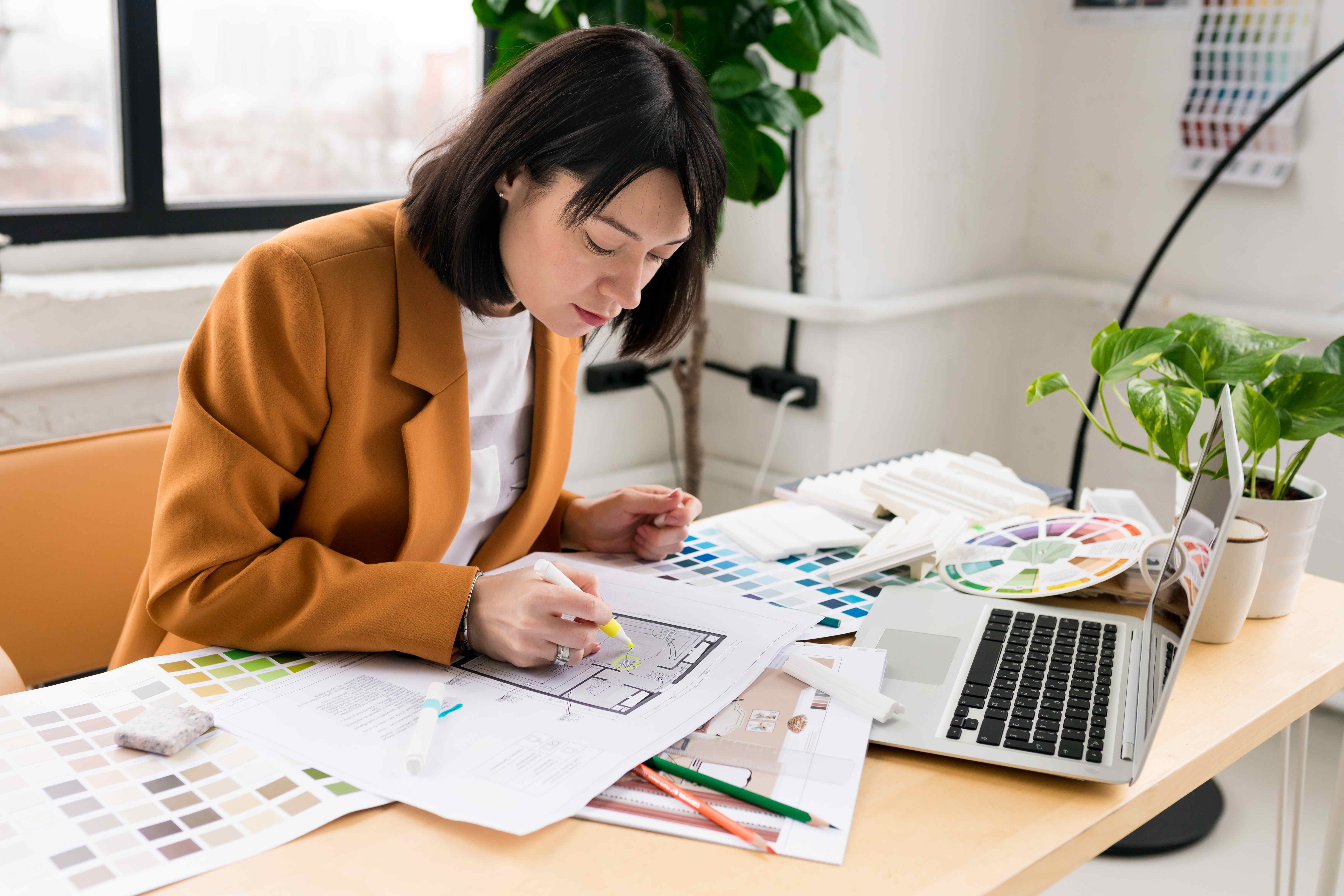 An artistic woman unleashes her creativity at her art table during Pisces season.