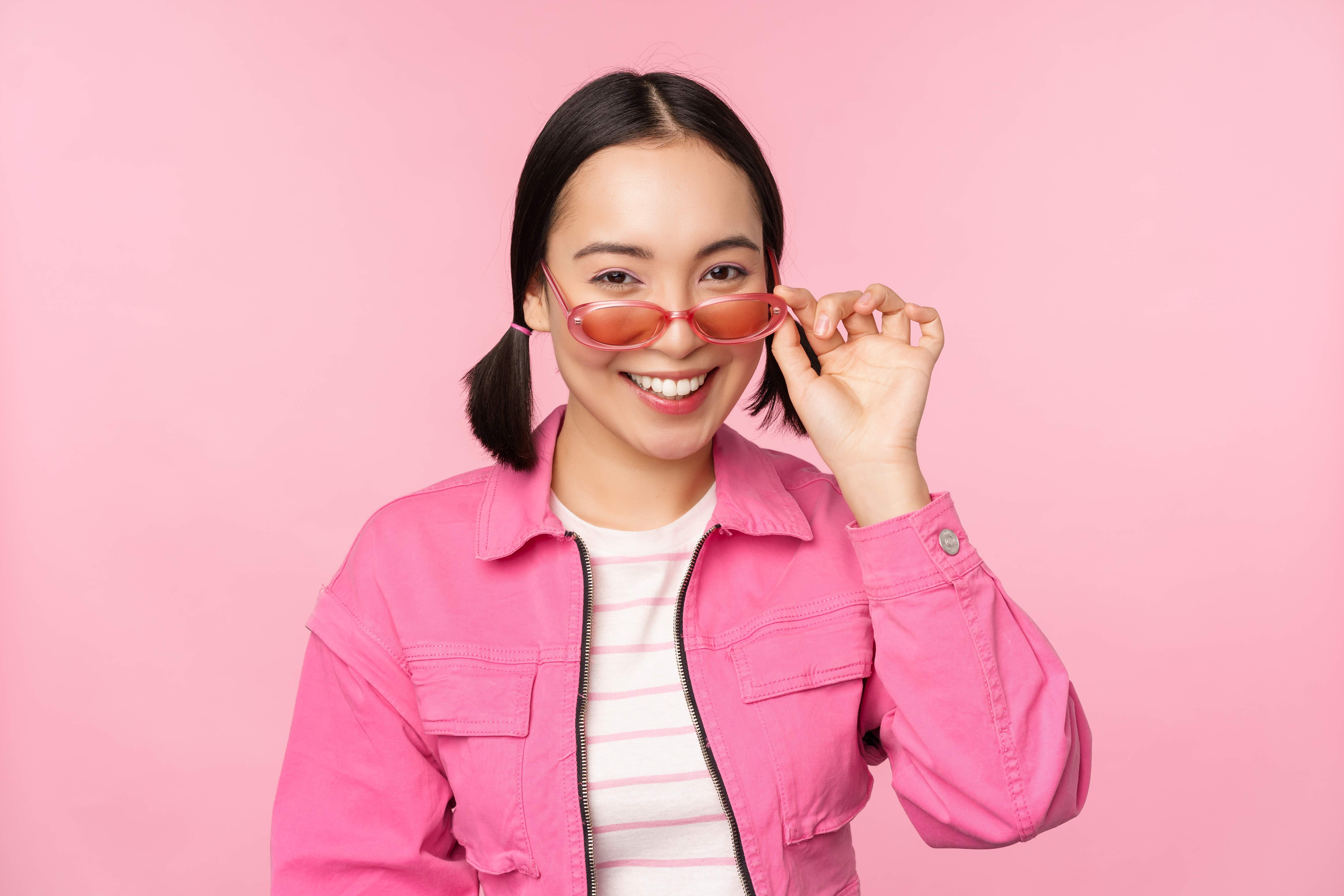 A woman shows off the cute pink sunglasses she got for her birthday.