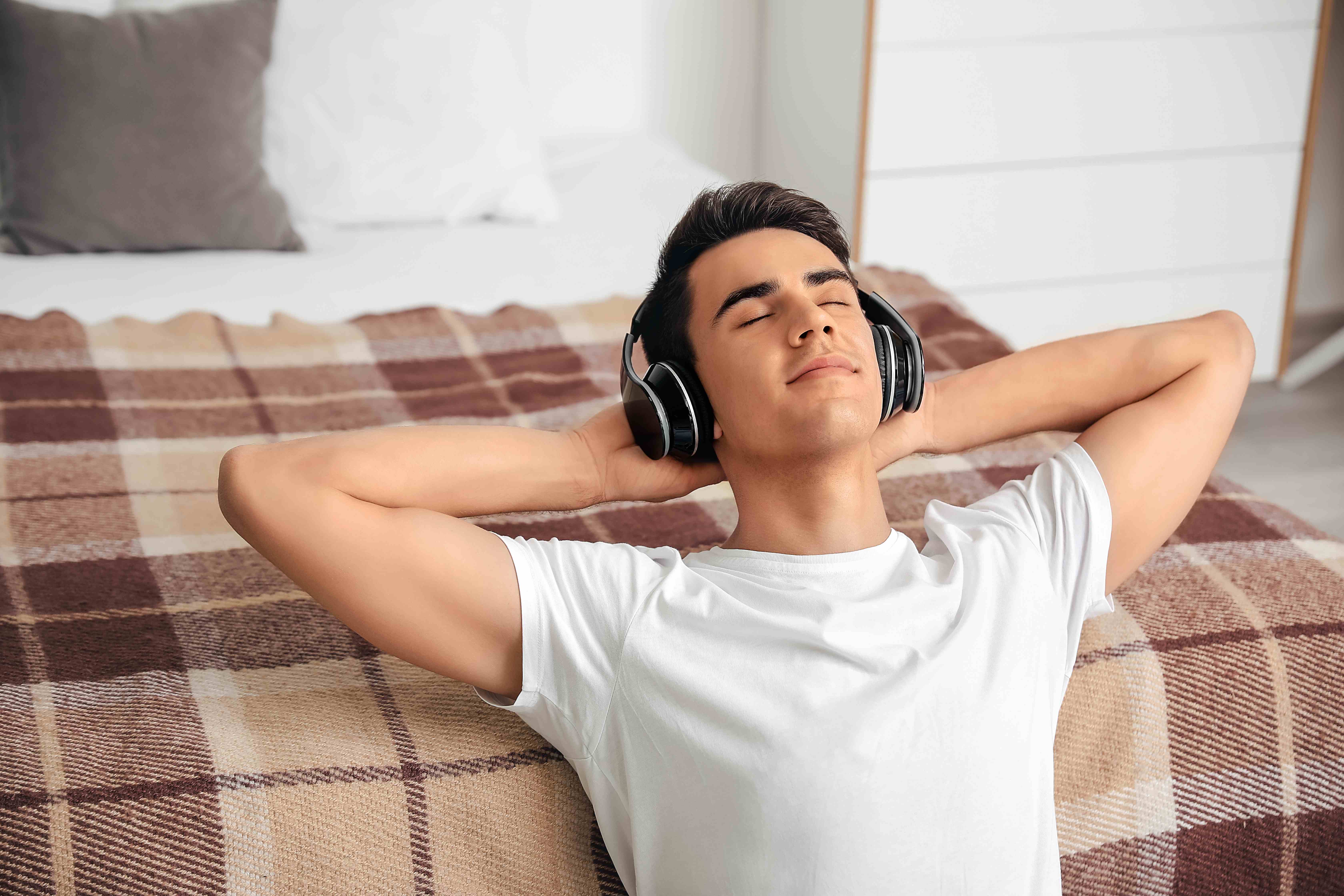 A man listens to a guided meditation to relax during Pisces season. 