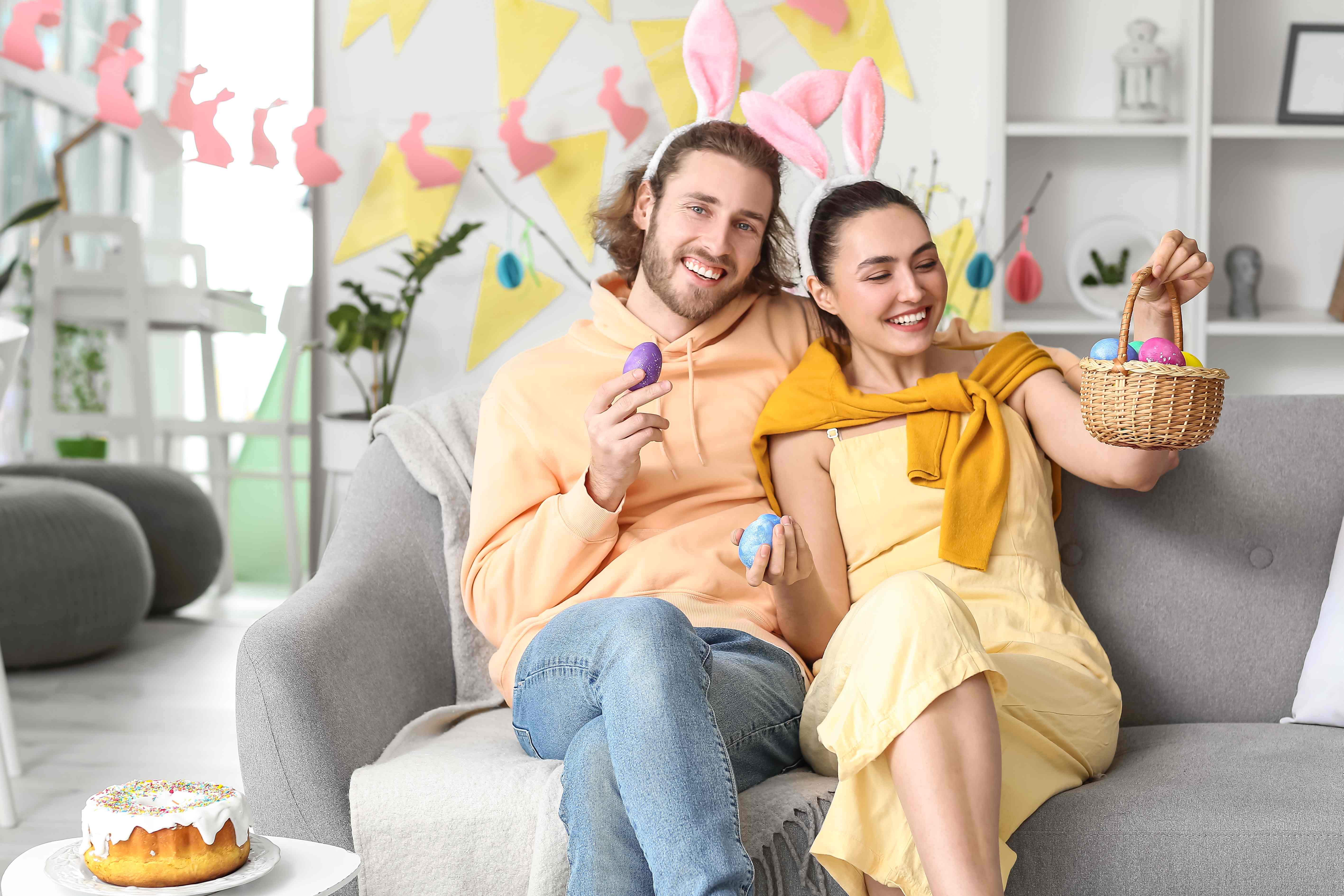 Two happy adults share the basket they filled in the family Easter egg hunt.