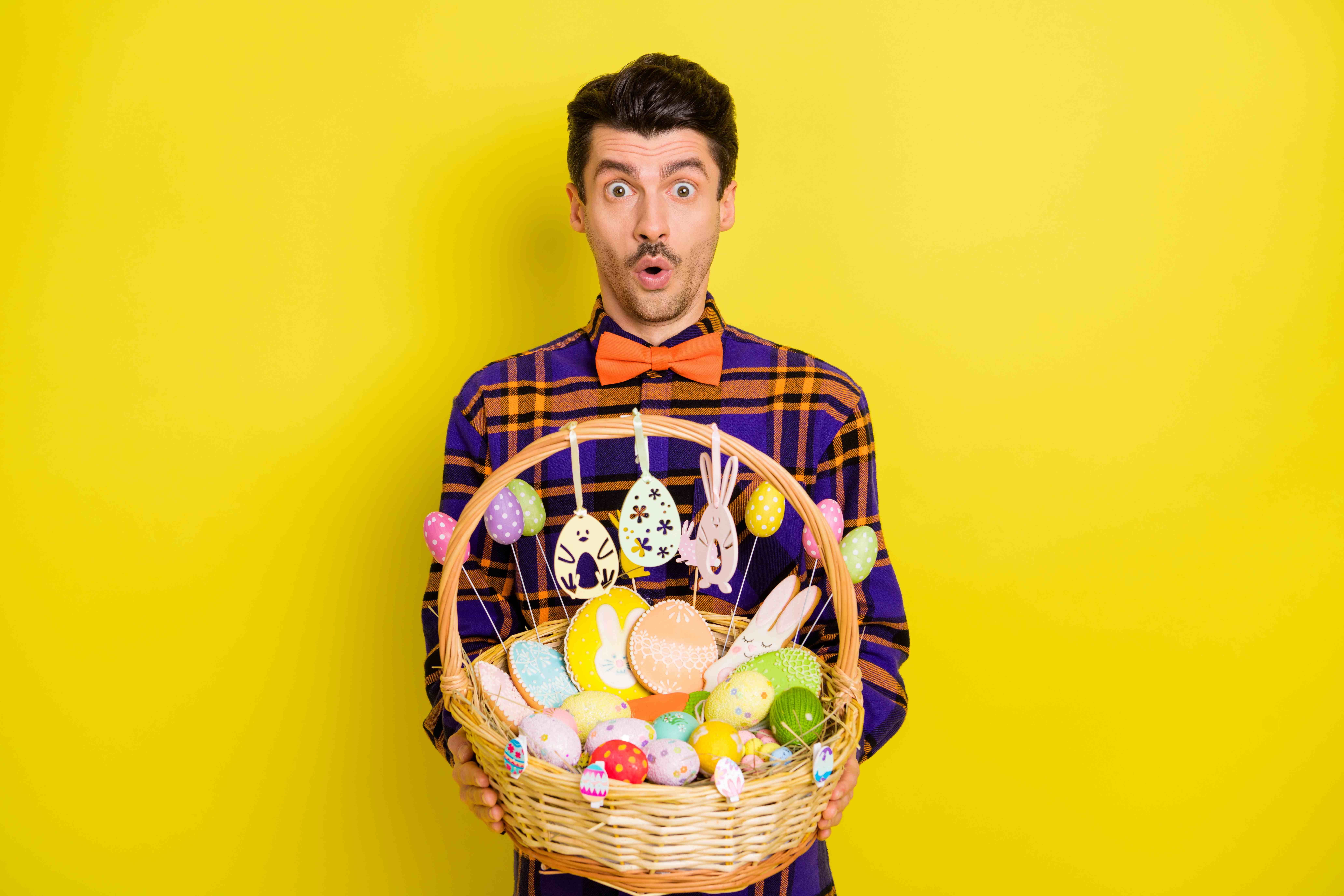 An adult man is excited to win an Easter basket full of cookies in a scavenger hunt.