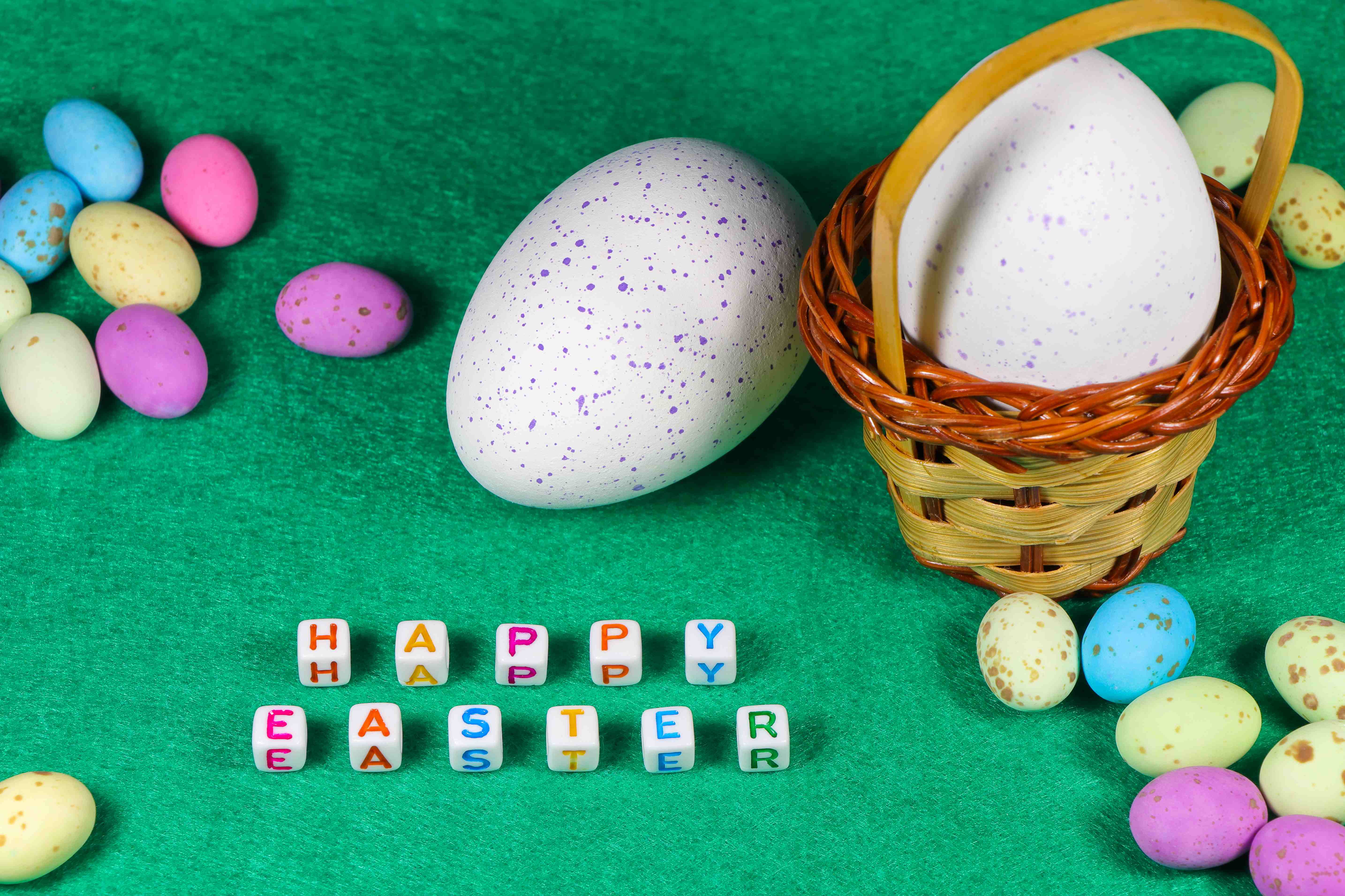 A colorful basket of eggs and letter beads that spell “Happy Easter.”