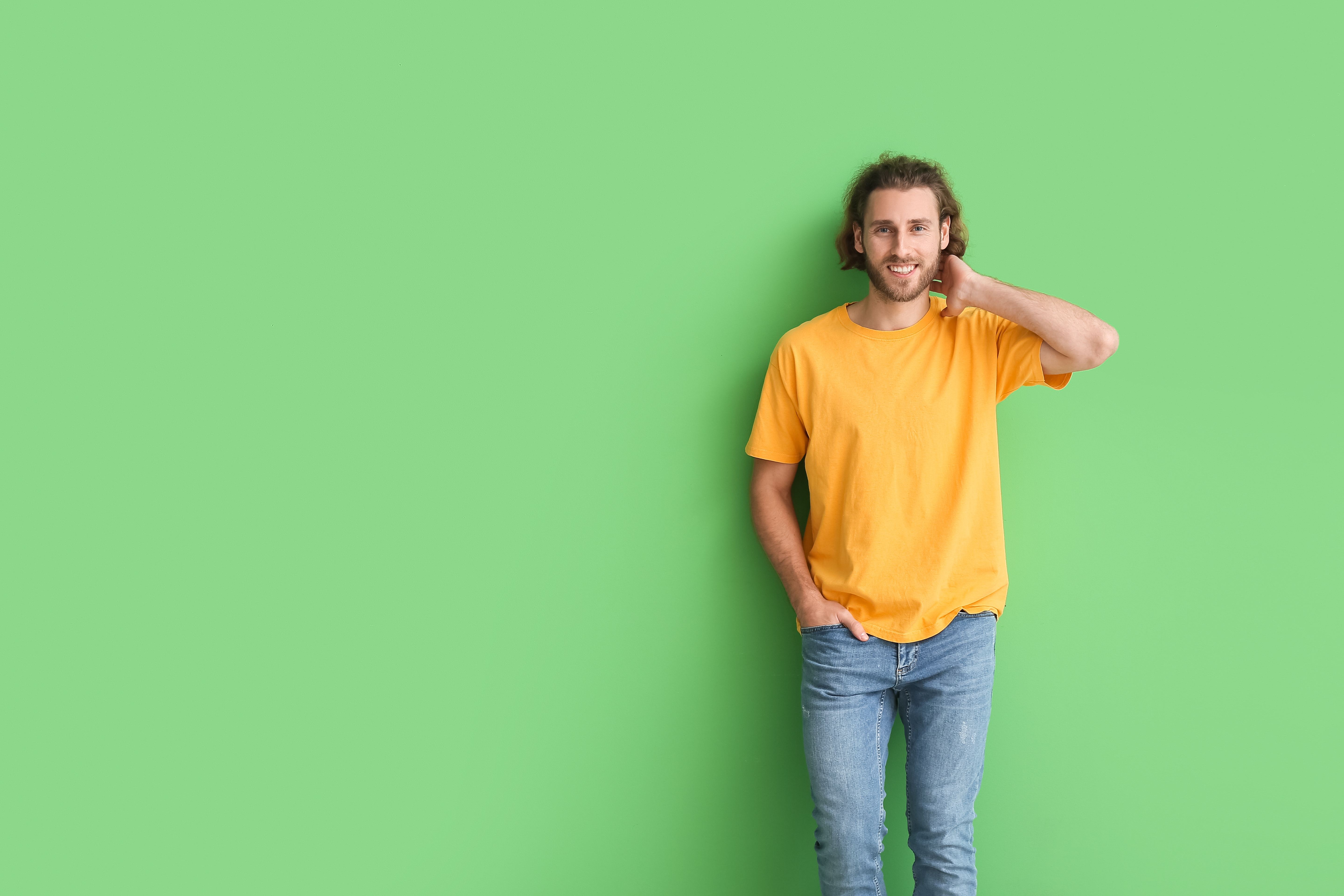 An Aries man shows off the new jeans he received as a birthday gift.