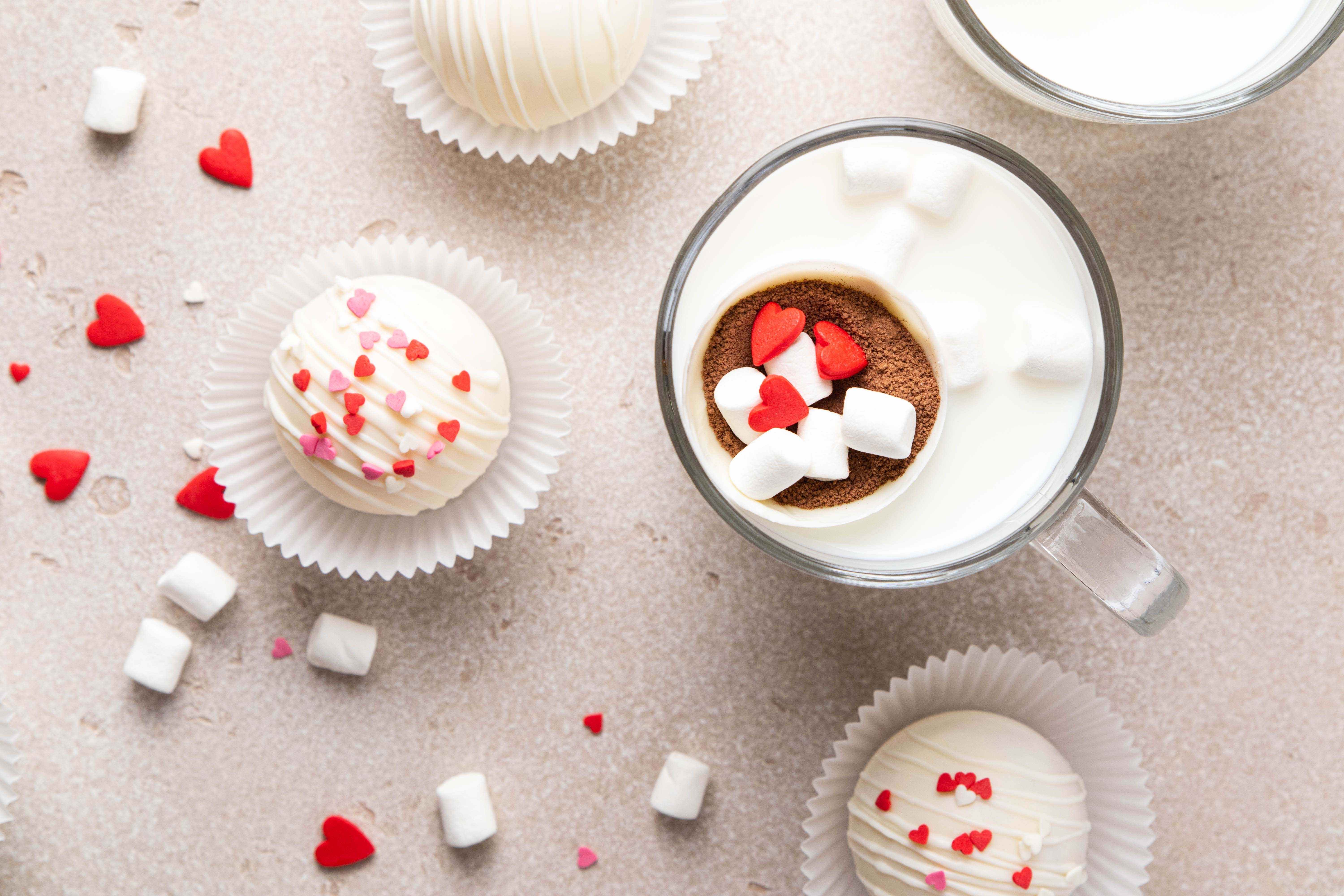 Hot cocoa bombs decorated with candy hearts to give as Valentine’s Day gifts.