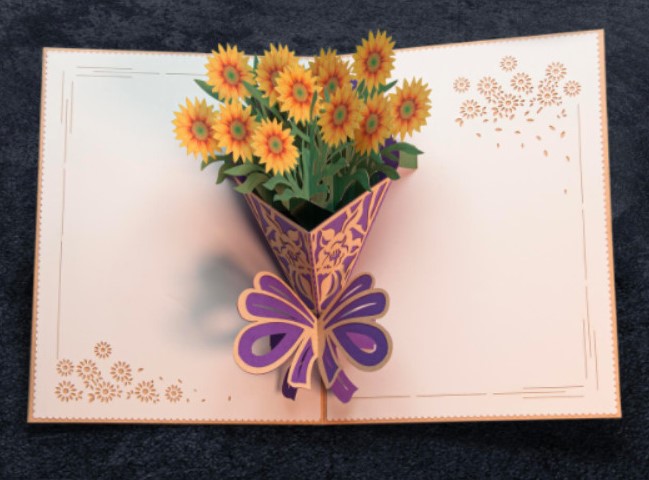 A Mother’s Day card with a cheerful pop-up bouquet of sunflowers inside.