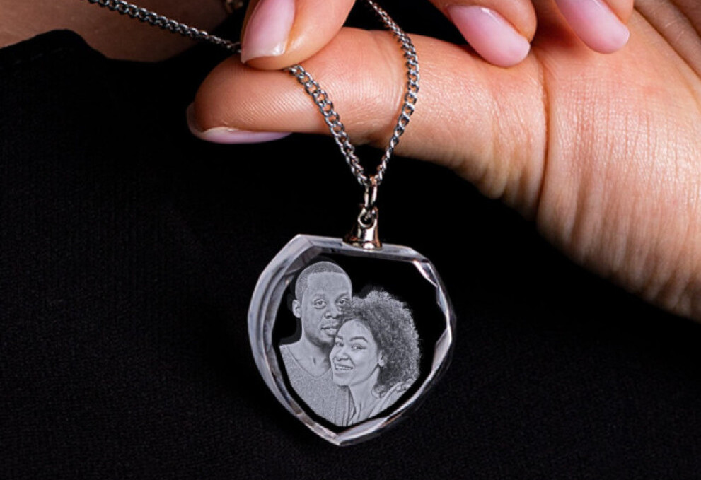 An engraved crystal necklace with a romantic couple’s portrait inside.