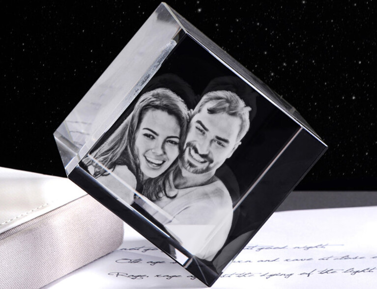 A custom made crystal gift with a 3D photo engraving of a happy couple inside.