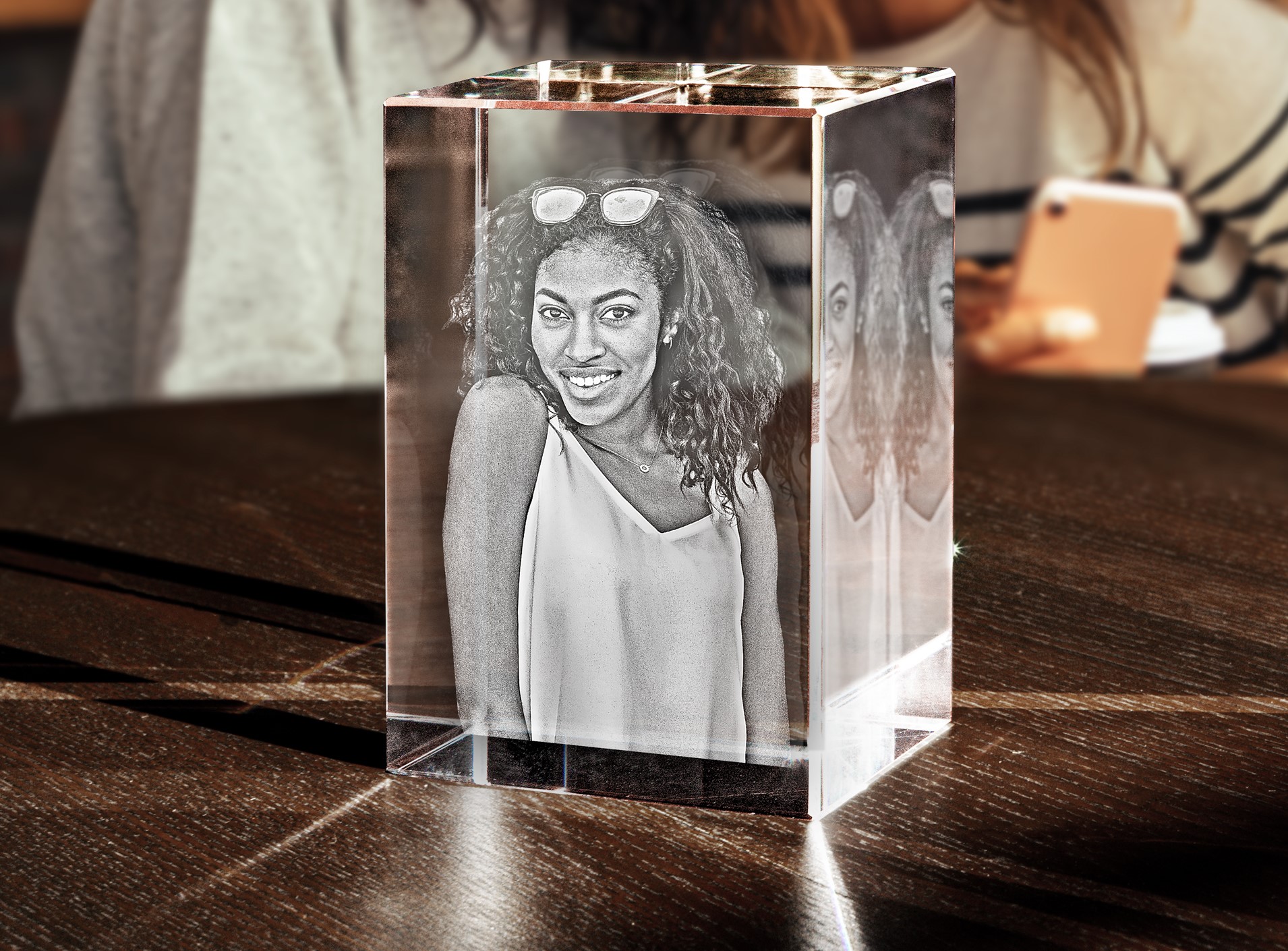 A woman surprises her friend with a 3D engraved photo crystal.
