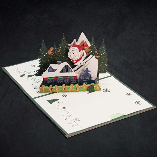 An open 3D Greeting Card with a pop-up holiday display of Santa in his sleigh